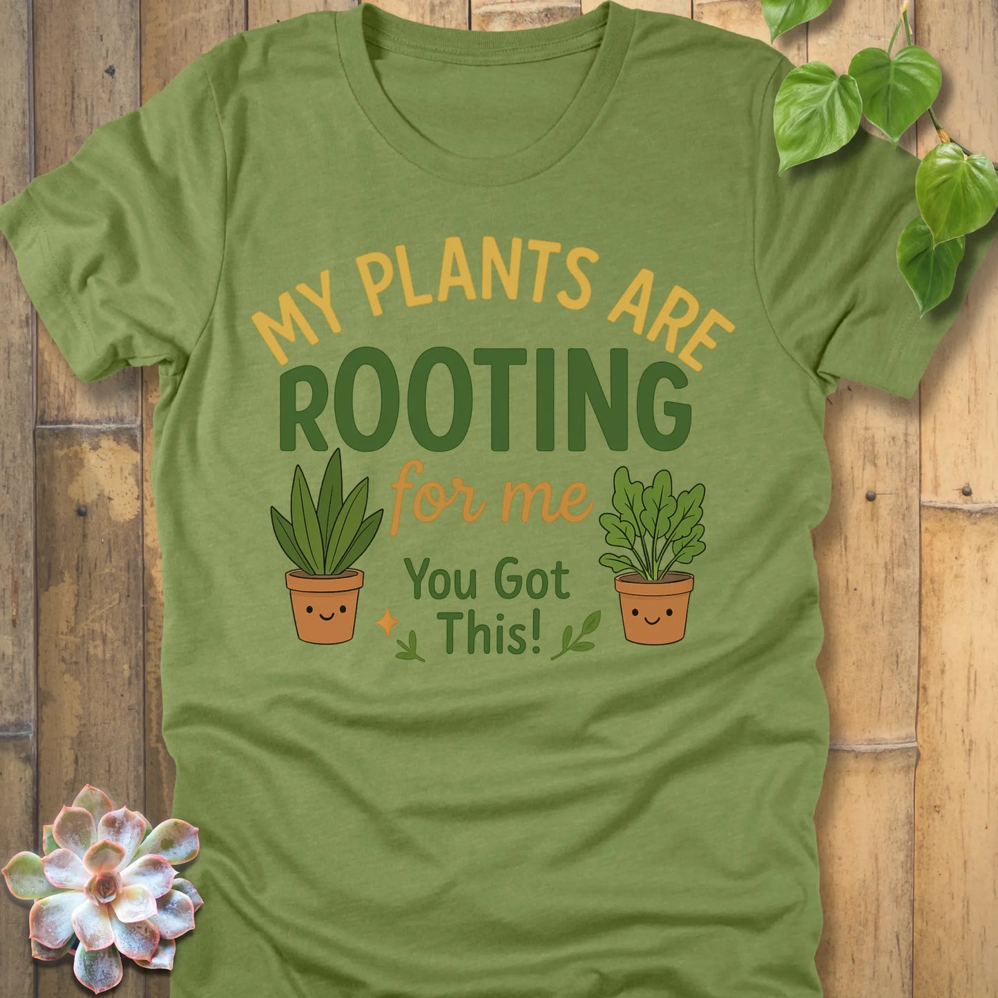 Heather Green t-shirt featuring the design Rooting For Me printed in bold letters and plants, gardening graphic tee.