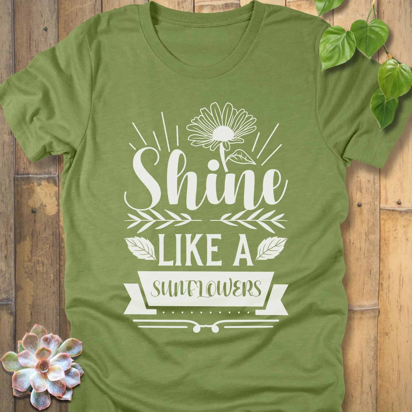 Heather Green t-shirt featuring the design Shine Like A Sunflower printed in bold letters with sunflower