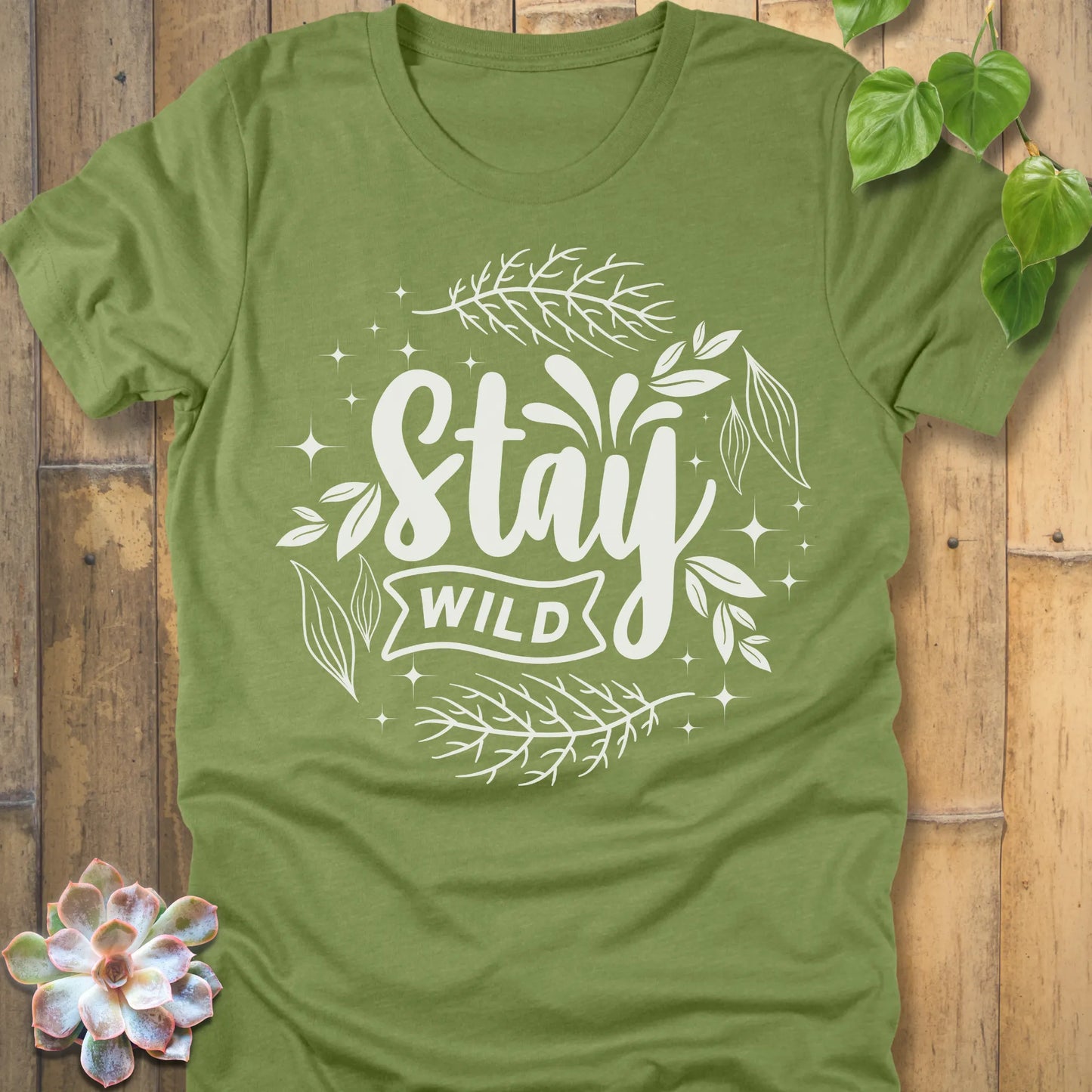 Heather Green t-shirt featuring the design Stay Wild printed in white letters, nature lover shirt.