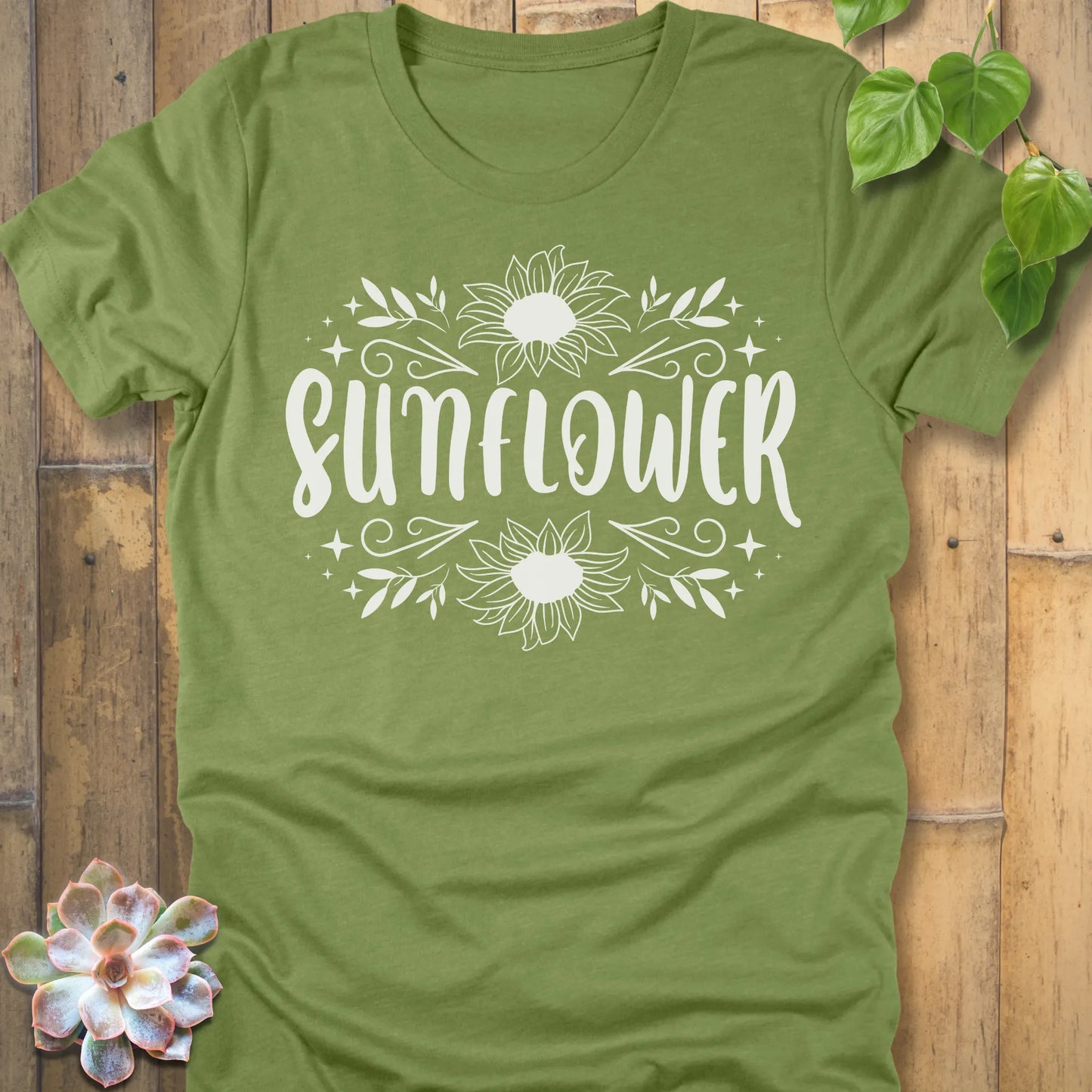 Heather Green t-shirt featuring the design Sunflower printed in white letters and sunflower, floral graphic tee.