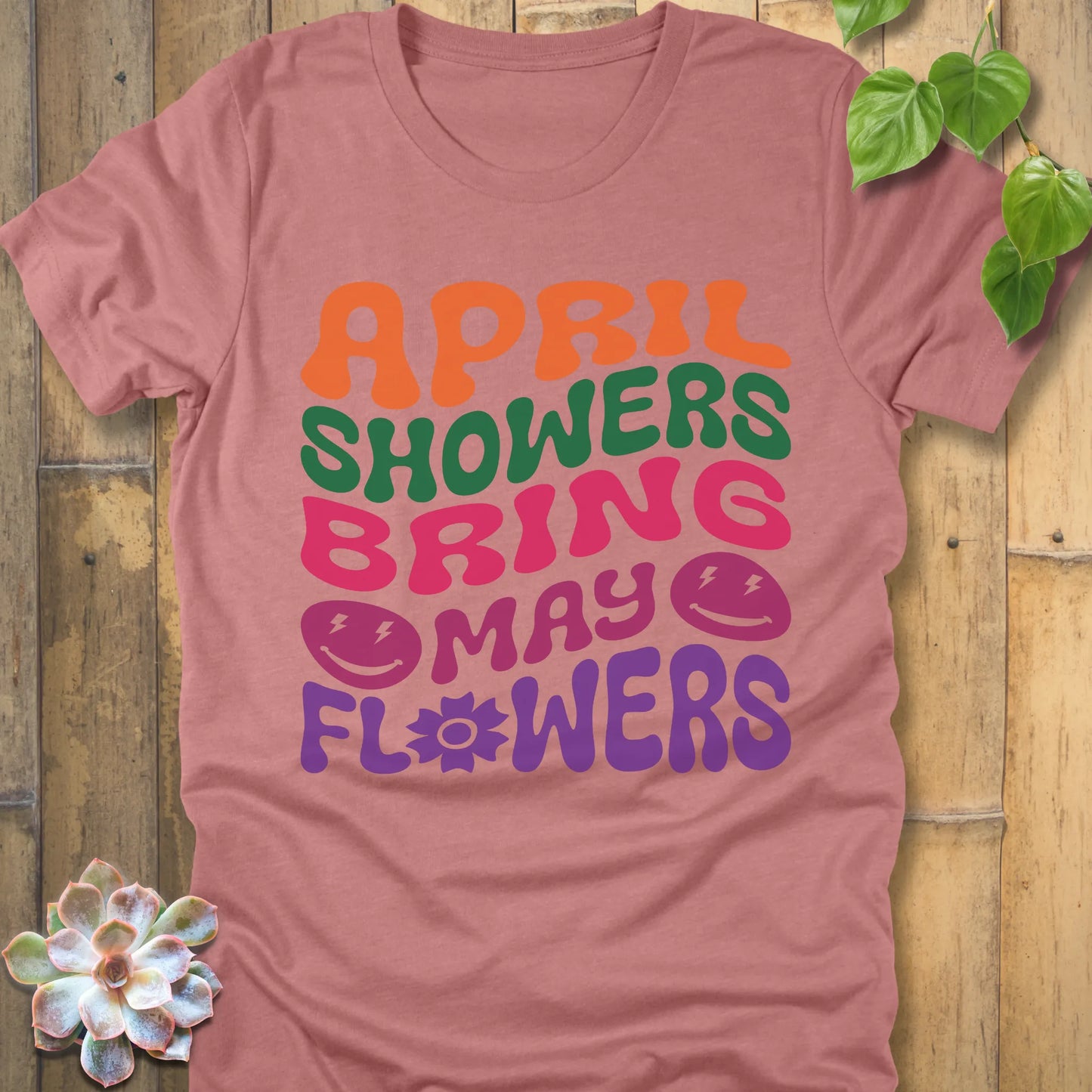 Heather Mauve t-shirt featuring the design April Shower printed in bold colorful letters, casual gardening shirt.