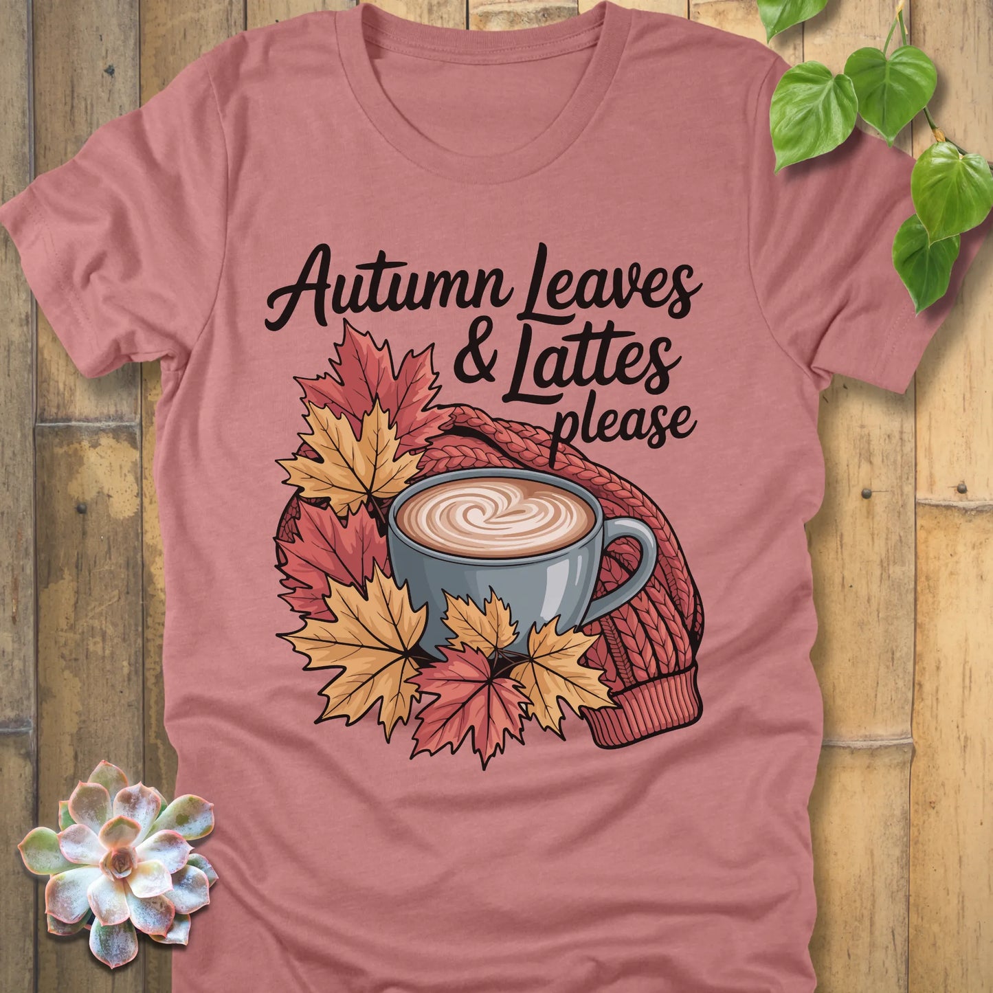 Heather Mauve t-shirt featuring the design Autumn Leaves & Lattes printed in black letters with a mug of coffee and leaves