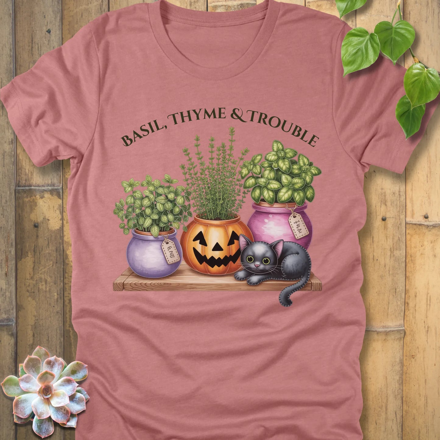 Heather Mauve t-shirt featuring the design "Basil, Thyme & Trouble" printed in bold green letters and a plants, cats 
