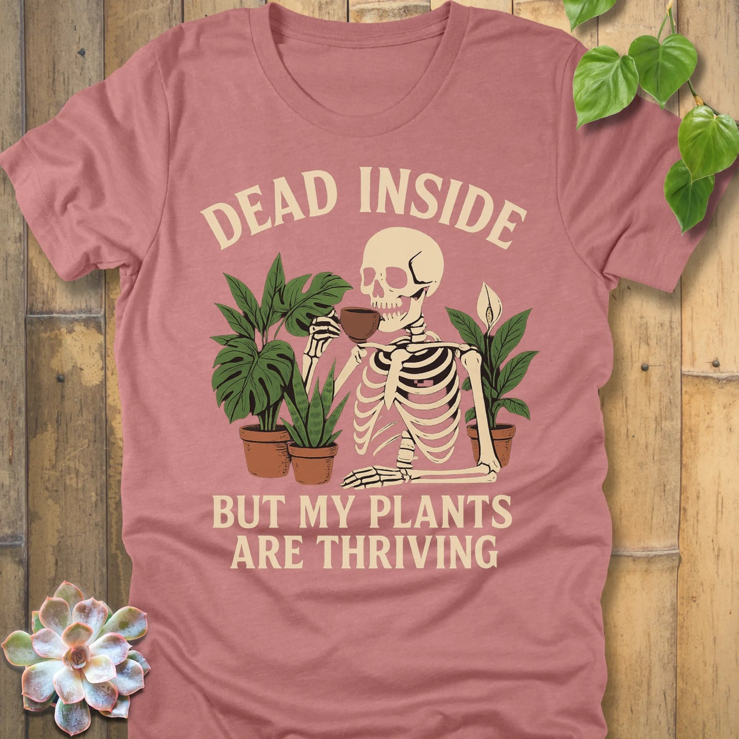 Heather Mauve t-shirt featuring the design Dead Inside printed in bold letters and plants, skeleton, funny graphic tee.