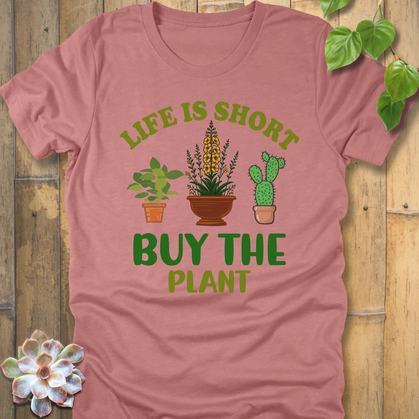 Heather Mauve t-shirt featuring the design Life is short, buy the plant printed in green letter with plant illustration