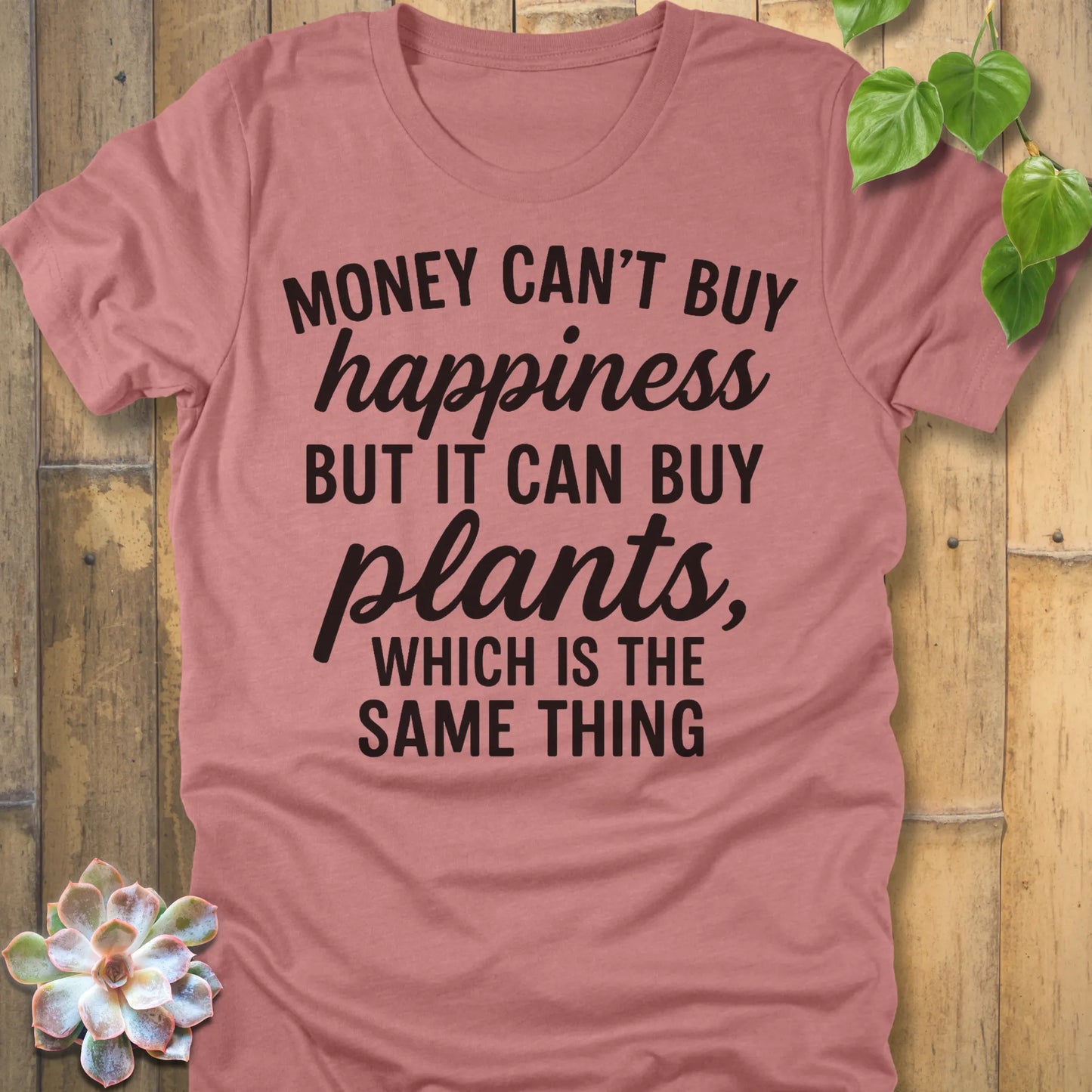 Heather Mauve t-shirt featuring the design Money Can’t Buy Happiness printed in bold black letters, motivational quote shirt.
