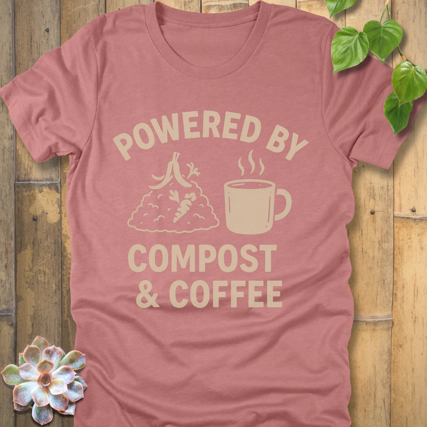 Heather Mauve t-shirt featuring the design Powered By Compost & Coffee printed in bold letters with mug of coffee