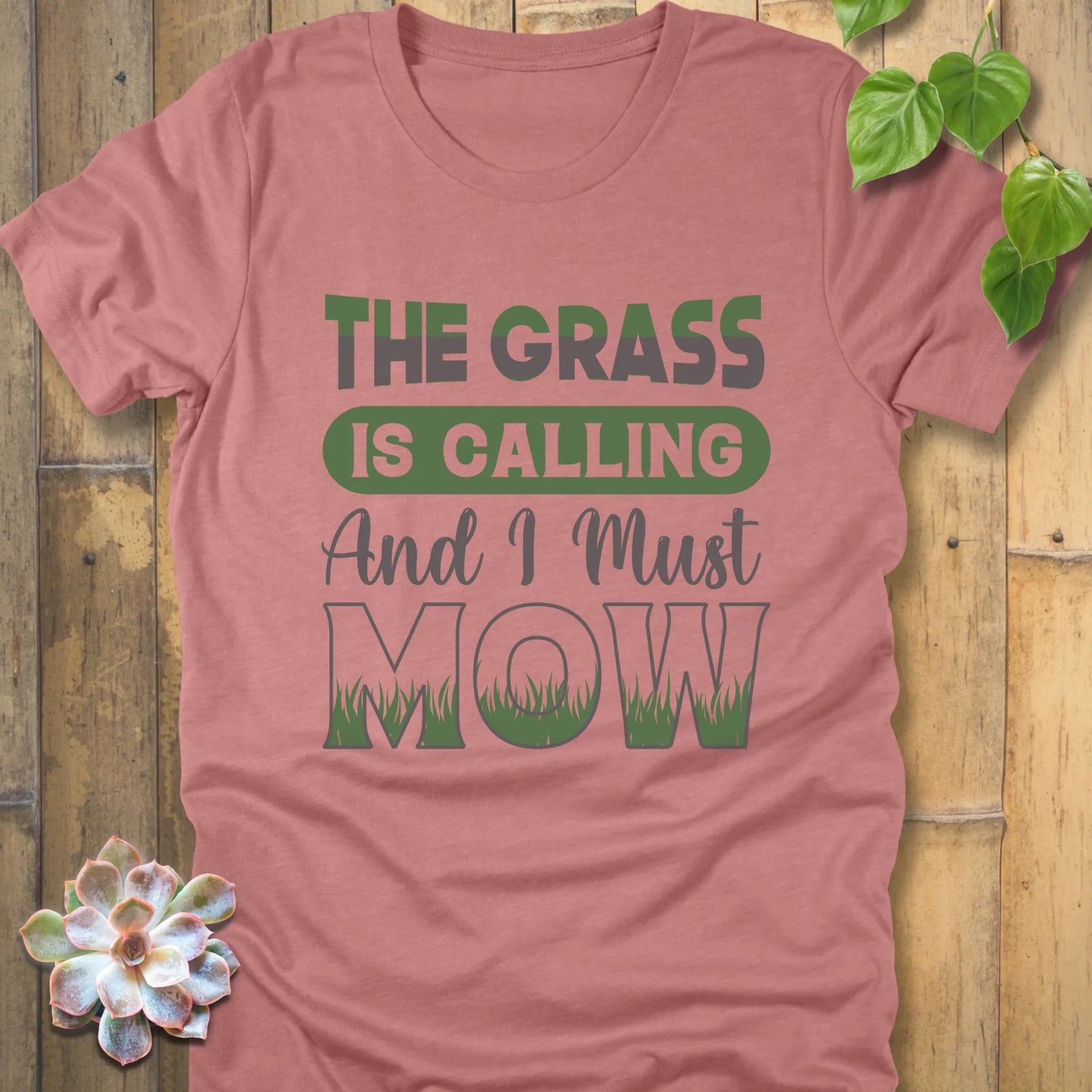 Heather Mauve t-shirt featuring the design The Grass is Calling and I Must Mow in bold letters and with grass