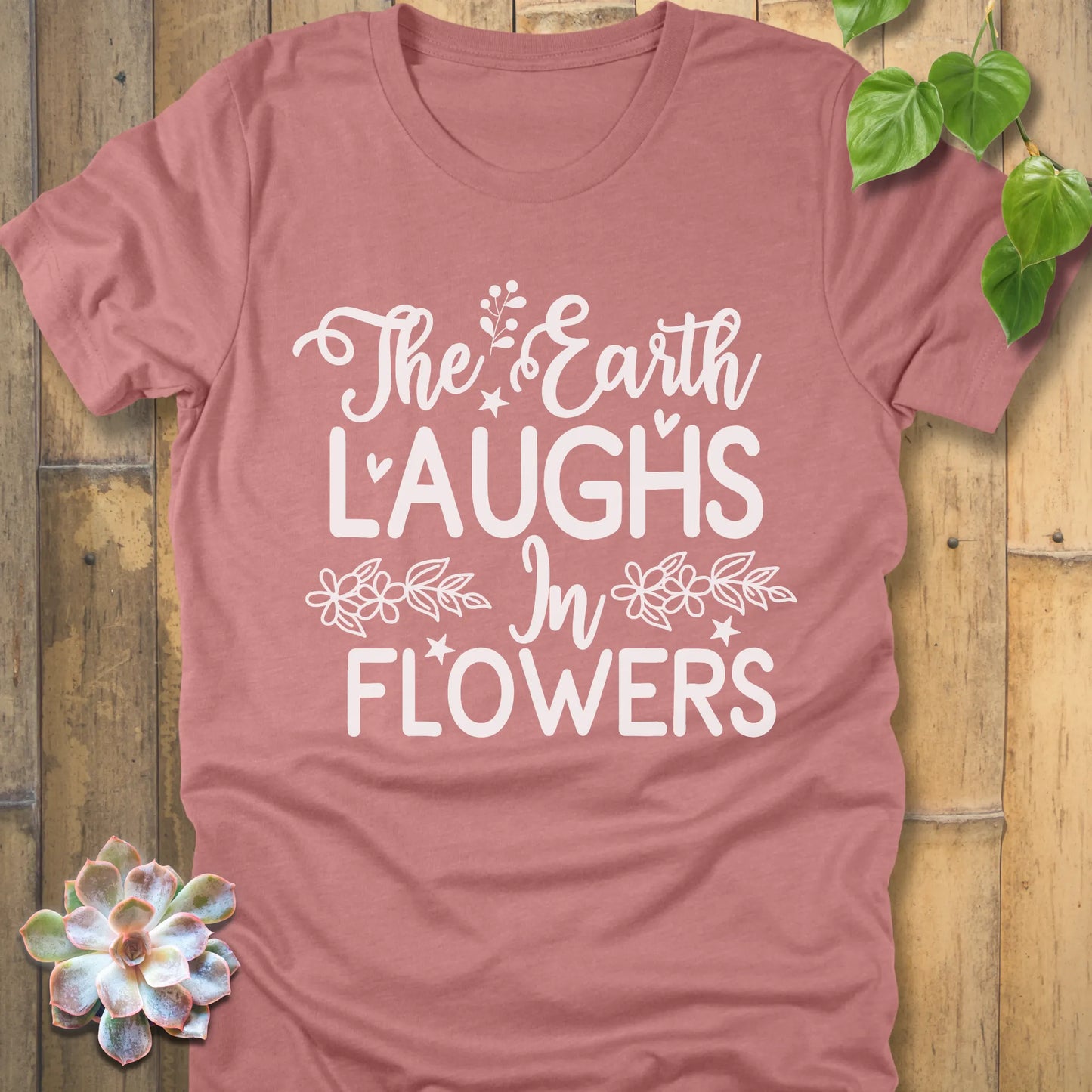 Heather Mauve t-shirt featuring the design The earth laughs in flowers printed in bold white letters