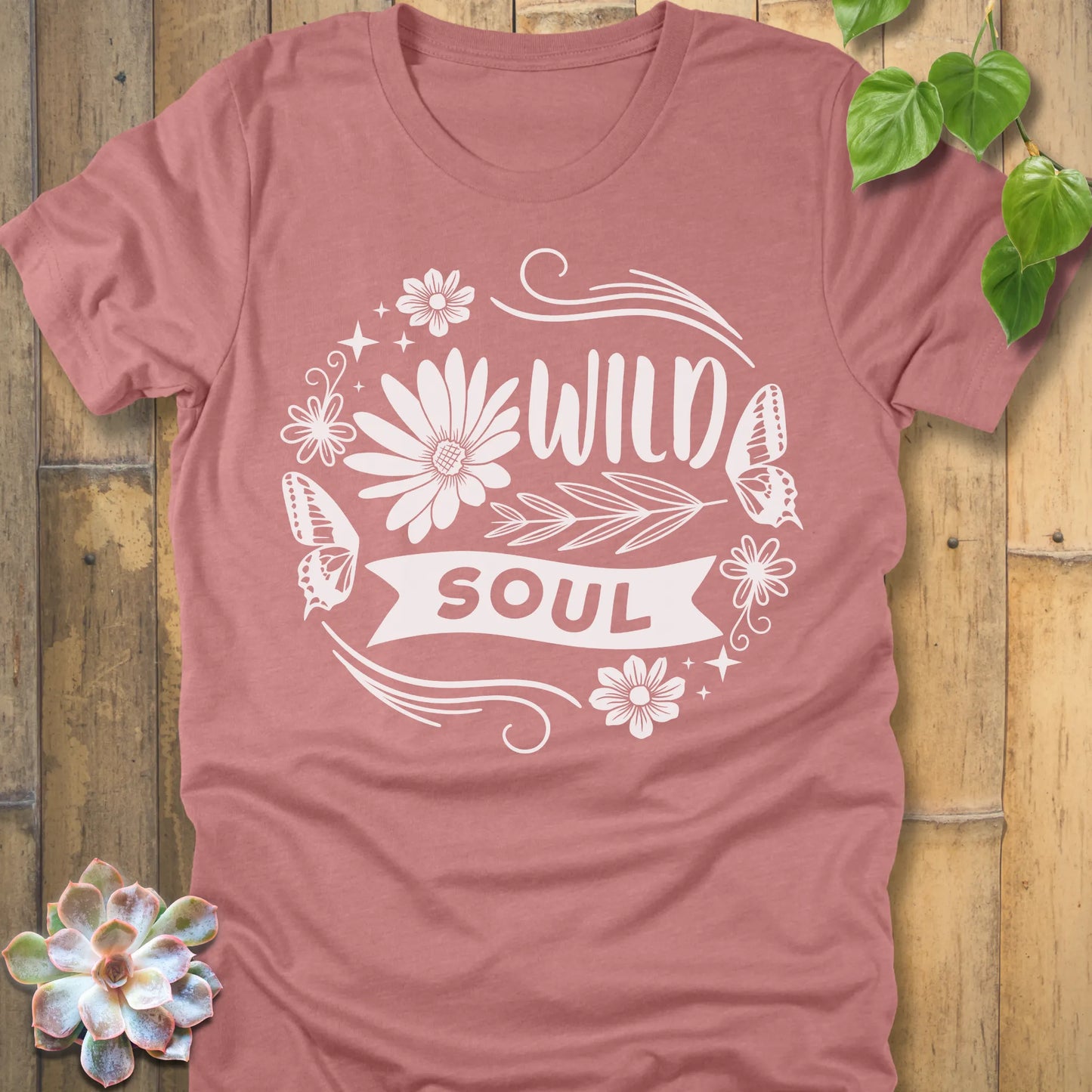 Heather Mauve t-shirt featuring the design Wild Soul printed in bold letters and flower, butterfly