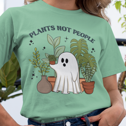Heathe Mint-Person wearing Bella Canvas 2001 t-shirt featuring the design Plants Not People printed in bold letters with halloween design a ghost holding plants - very sweet