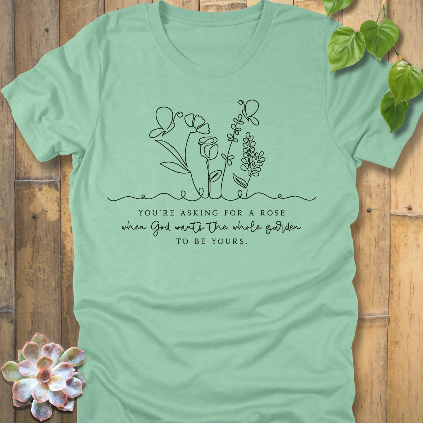 Heather Mint t-shirt featuring the design Asking for a rose, printed in black letters, soft pastel cotton shirt