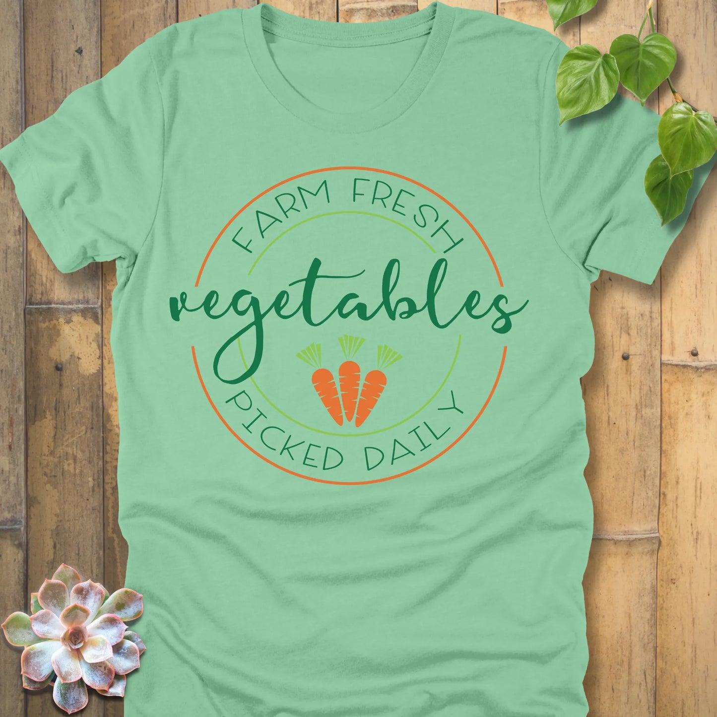 Heather Mint t-shirt featuring the design Fresh Vegetables printed in green letters and some carrots, organic vegetable lover shirt.