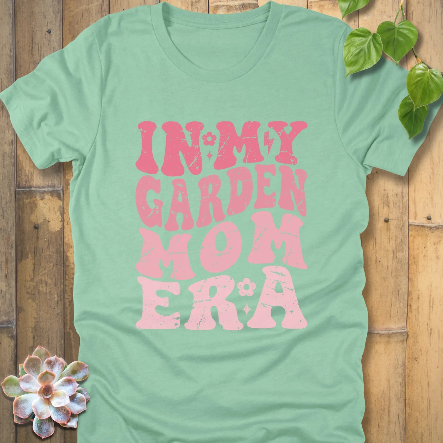 Heather Mint t-shirt featuring the design In My Garden Mom Era printed in bold pink letters, chic outdoor gardening wear.