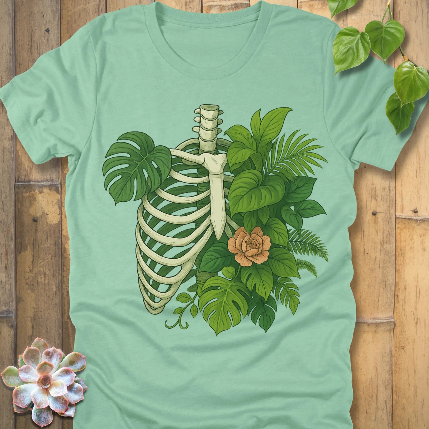 Heather Mint t-shirt featuring the design Jungle Bones printed in bones, leaves and flowers, casual jungle graphic shirt.