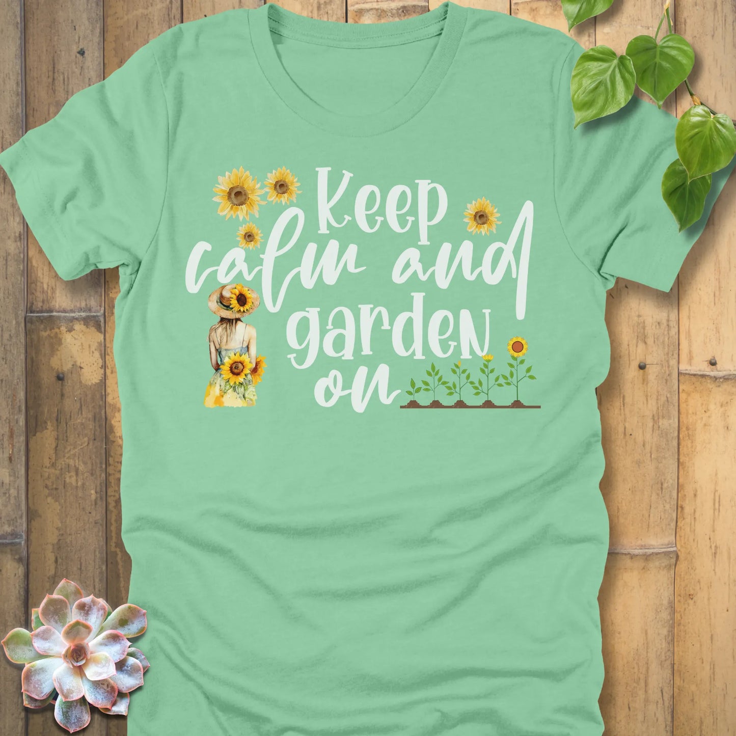 Heather Mint t-shirt featuring the design Keep Calm printed in white letters and sunflowers