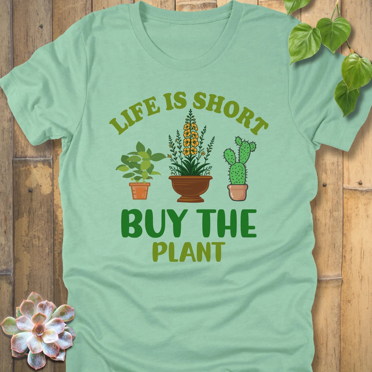 Heather Mint t-shirt featuring the design Life is short, buy the plant printed in green letter with plant illustration