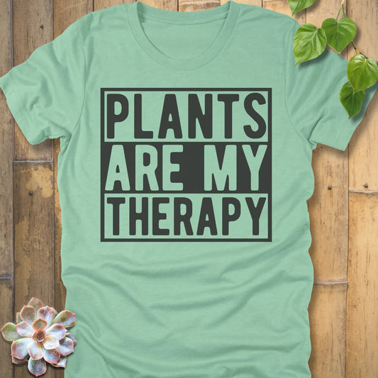 Heather Mint t-shirt featuring the design Plants Are My Therapy printed in bold letters, plant lover shirt.