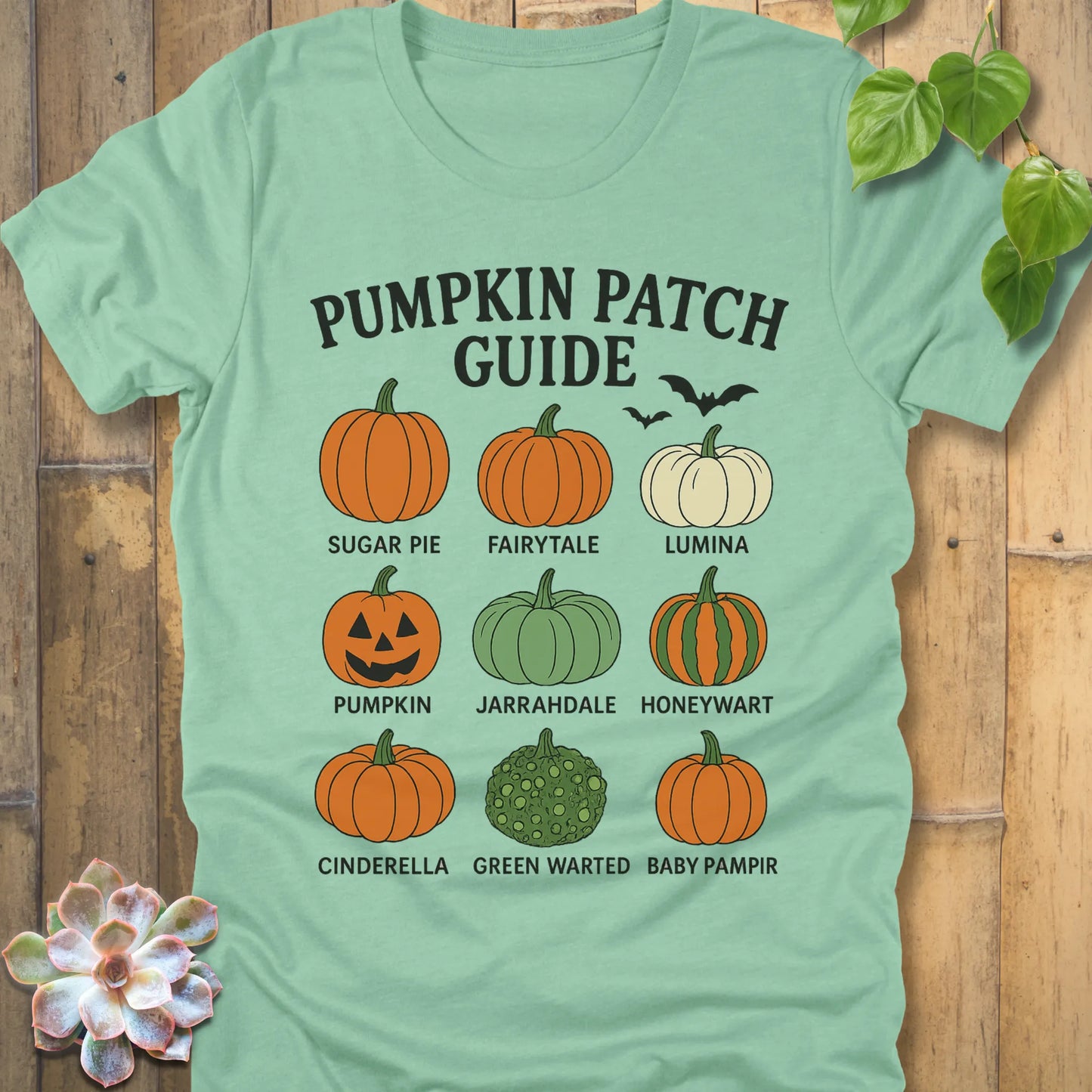 Heather Mint t-shirt featuring the design Pumpkin Patch Guide printed in bold black letters and pumpkin