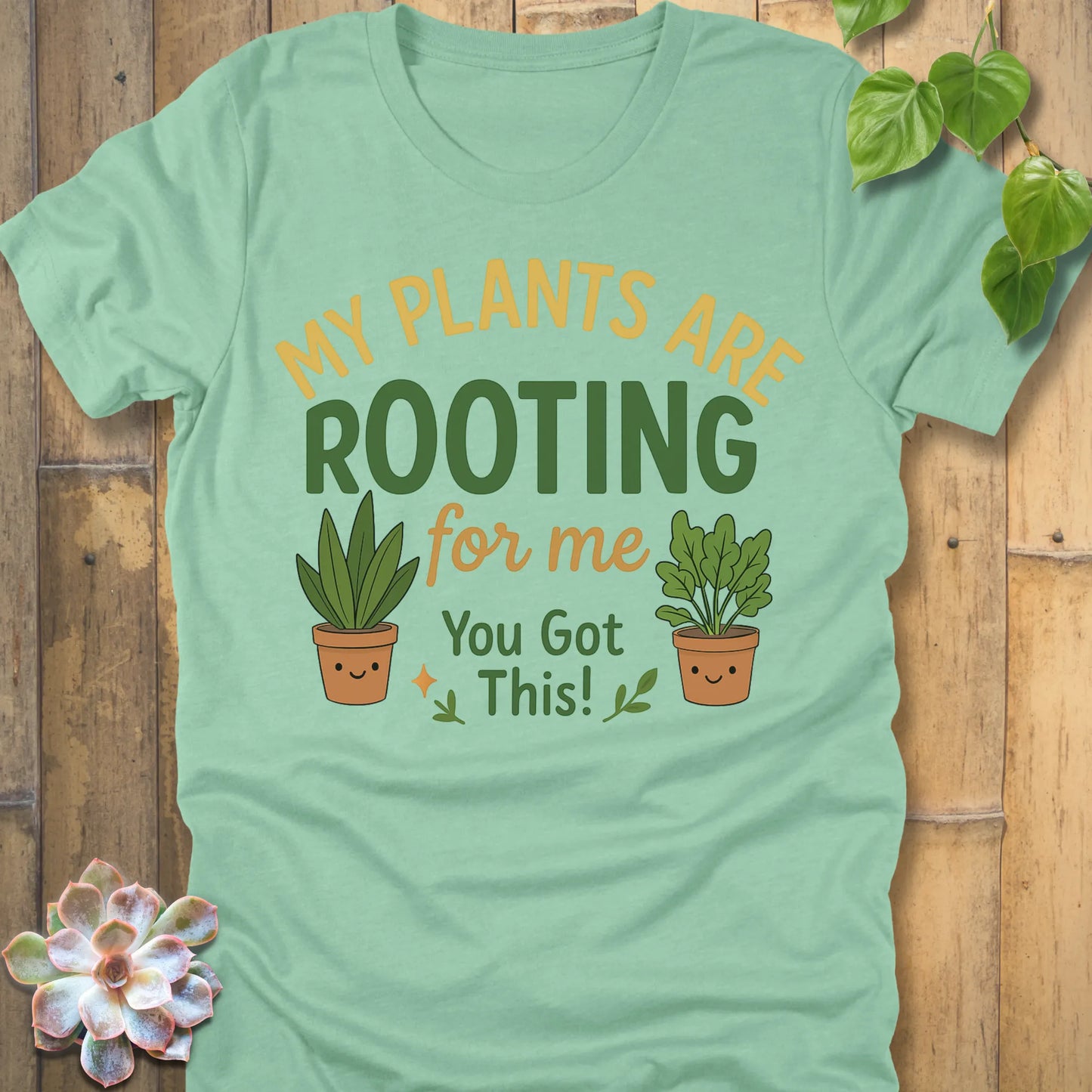 Heather Mint t-shirt featuring the design Rooting For Me printed in bold letters and plants, gardening graphic tee.
