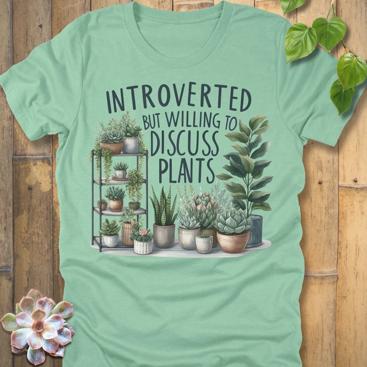 Heather Mint t-shirt featuring the design Willing To Discuss Plants printed in bold black letters, funny plant lover shirt.