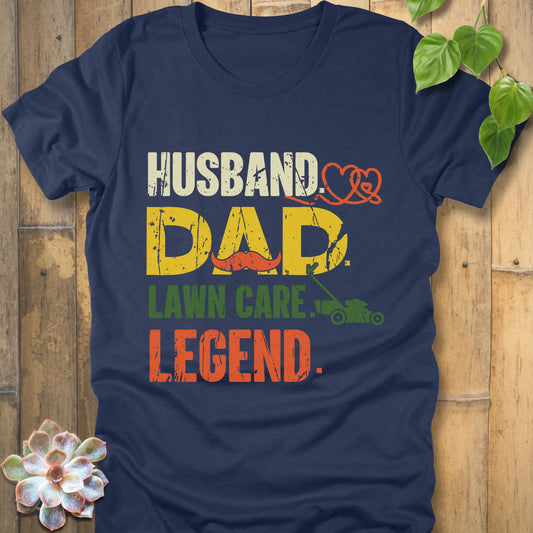 Heather Navy t-shirt featuring the design "Husband, Dad lawn care legend" printed in bold letters