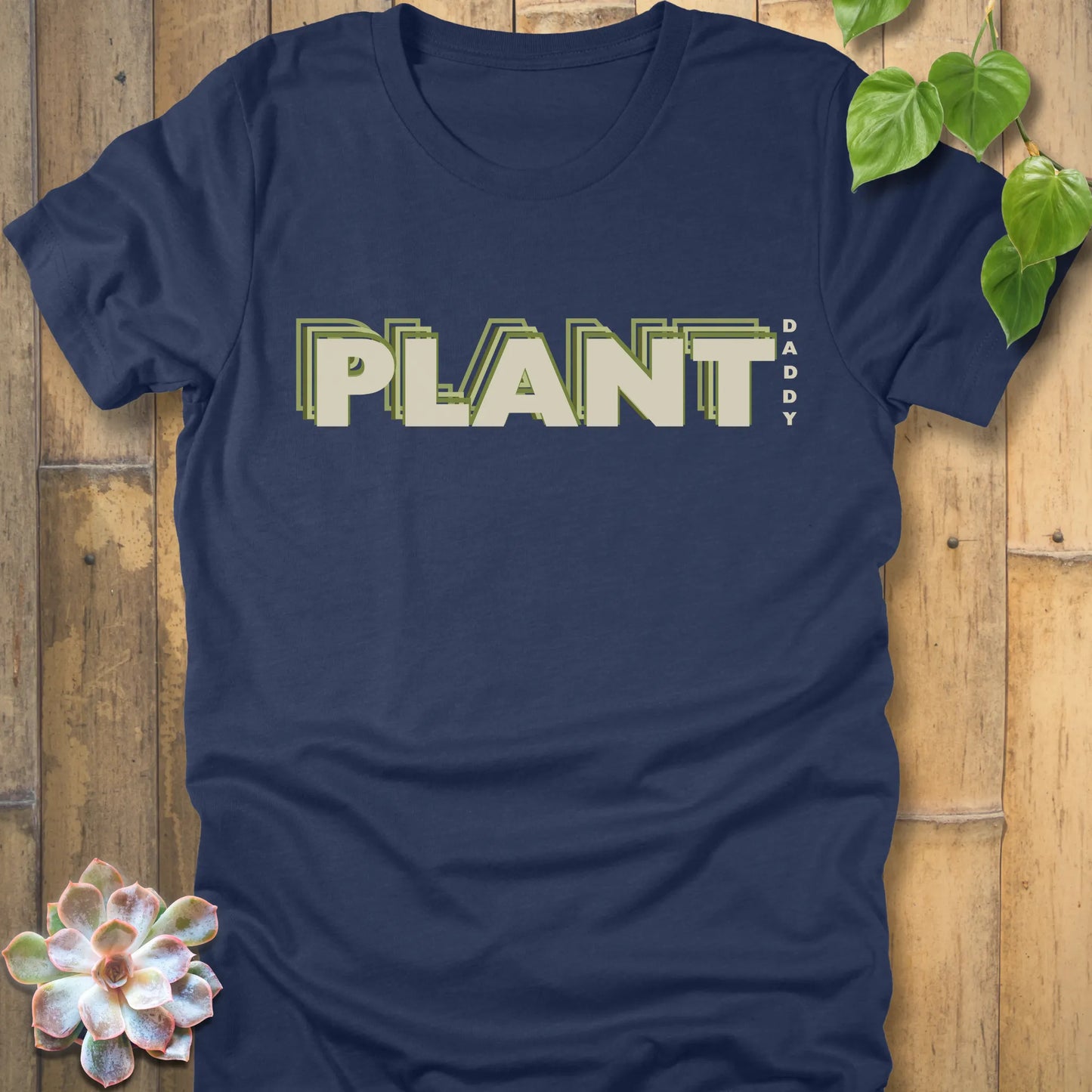 Heather Navy t-shirt featuring the design Plant Daddy printed in bold letters, soft cotton botanical shirt.