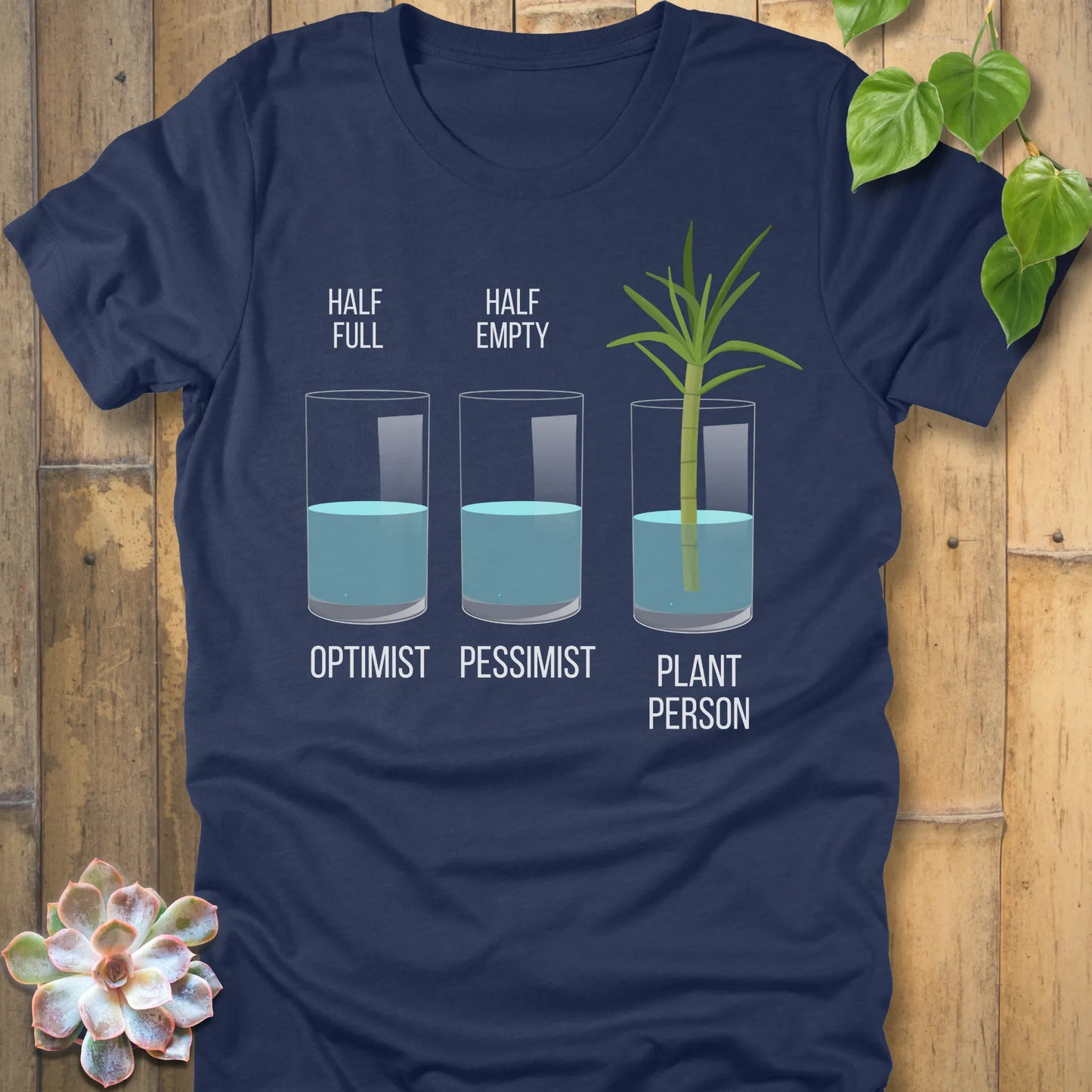 Heather Navy t-shirt featuring the design Plant Person printed in bold letters printed in glass of water, and a plant