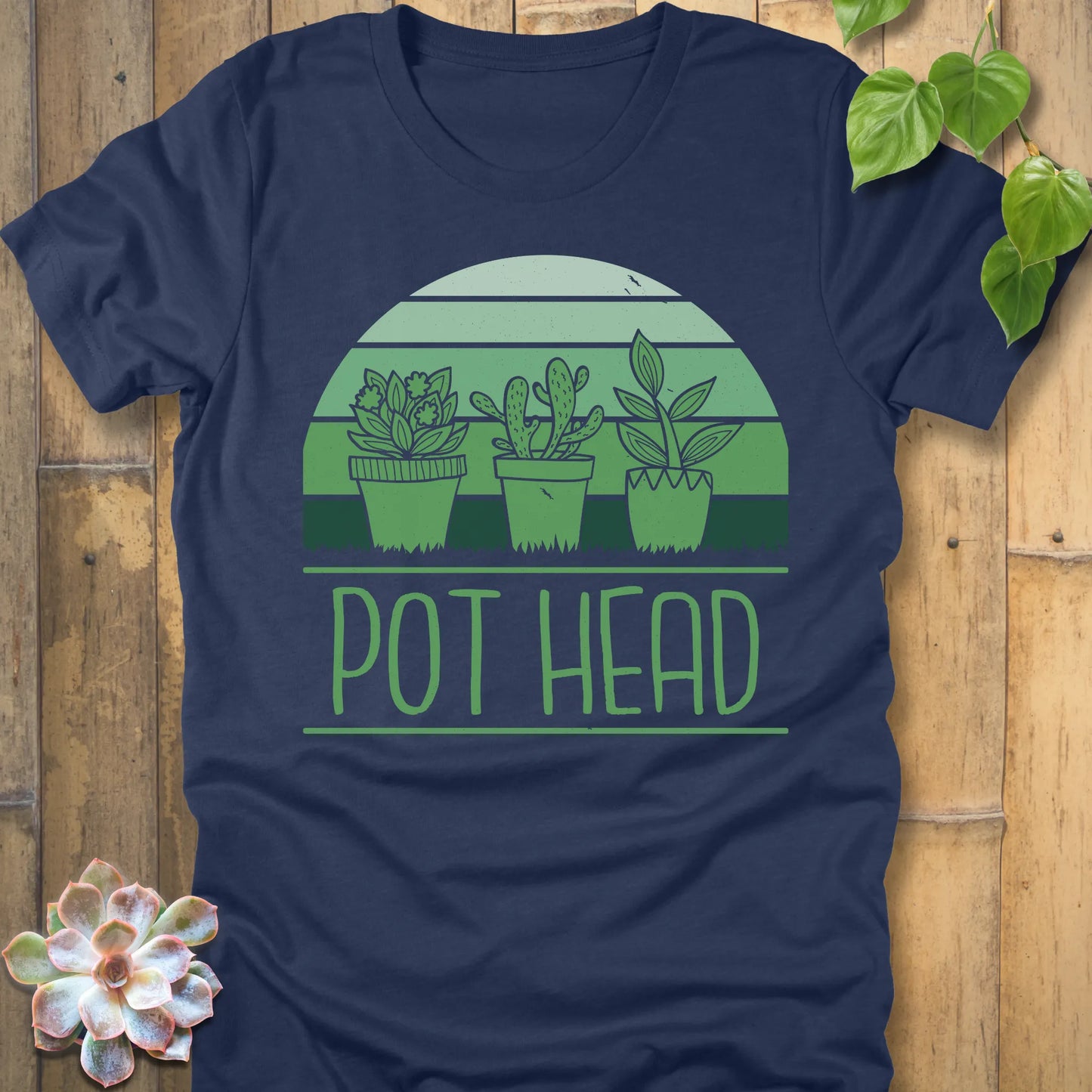 Heather Navy t-shirt featuring the design Pot Head printed in bold letters and 3 different plant in the pots, funny plant lover shirt.