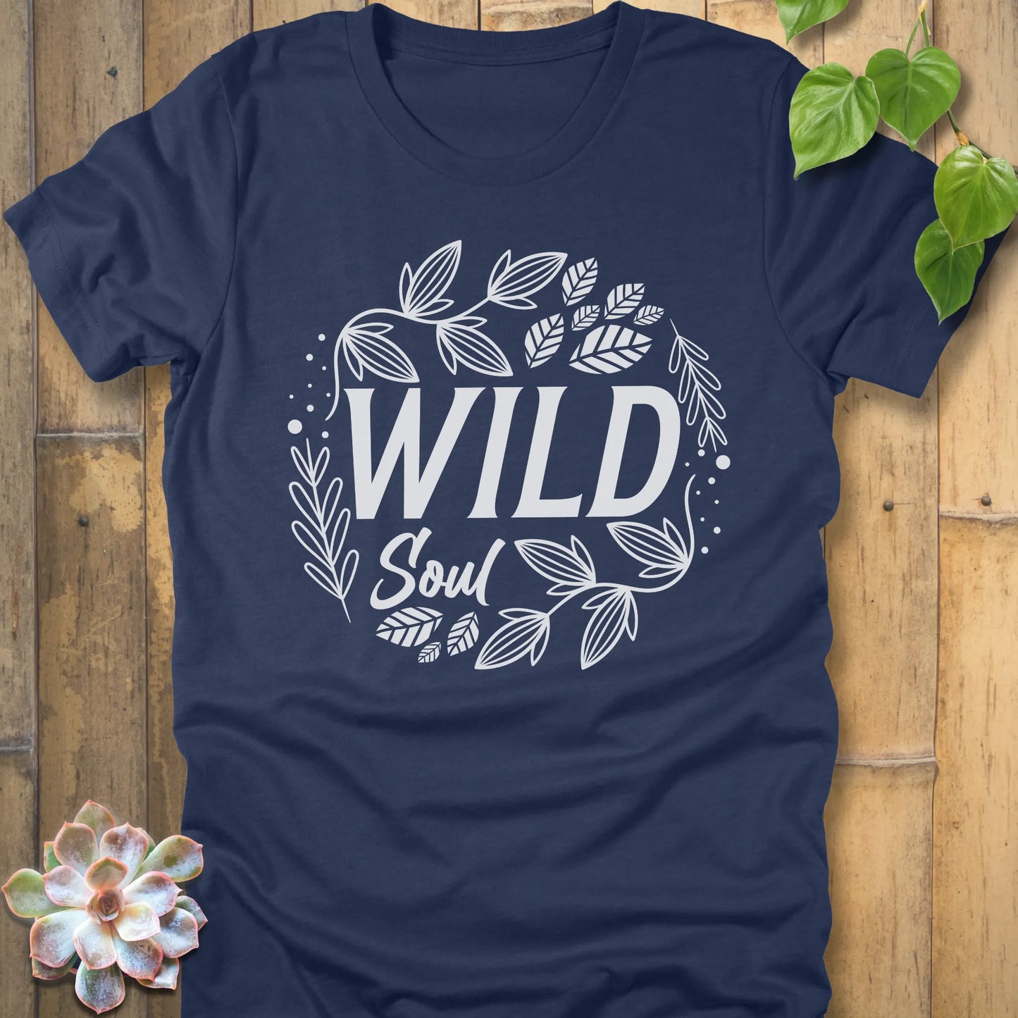 Heather Navy t-shirt featuring the design Wild Soul printed in black letters with leaves