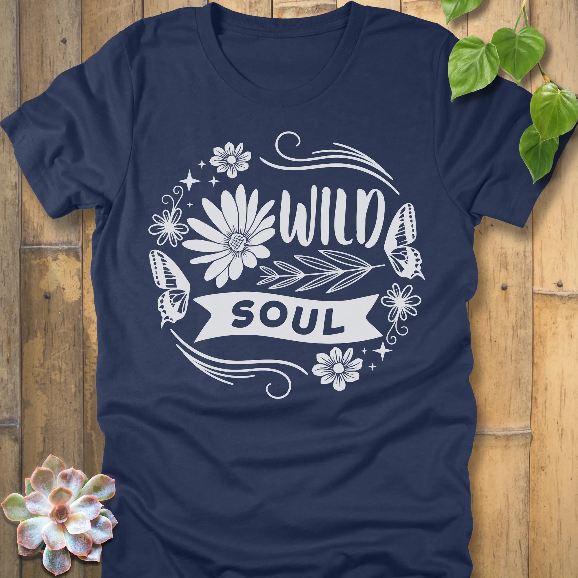 Heather Navy t-shirt featuring the design Wild Soul printed in bold letters and flower, butterfly