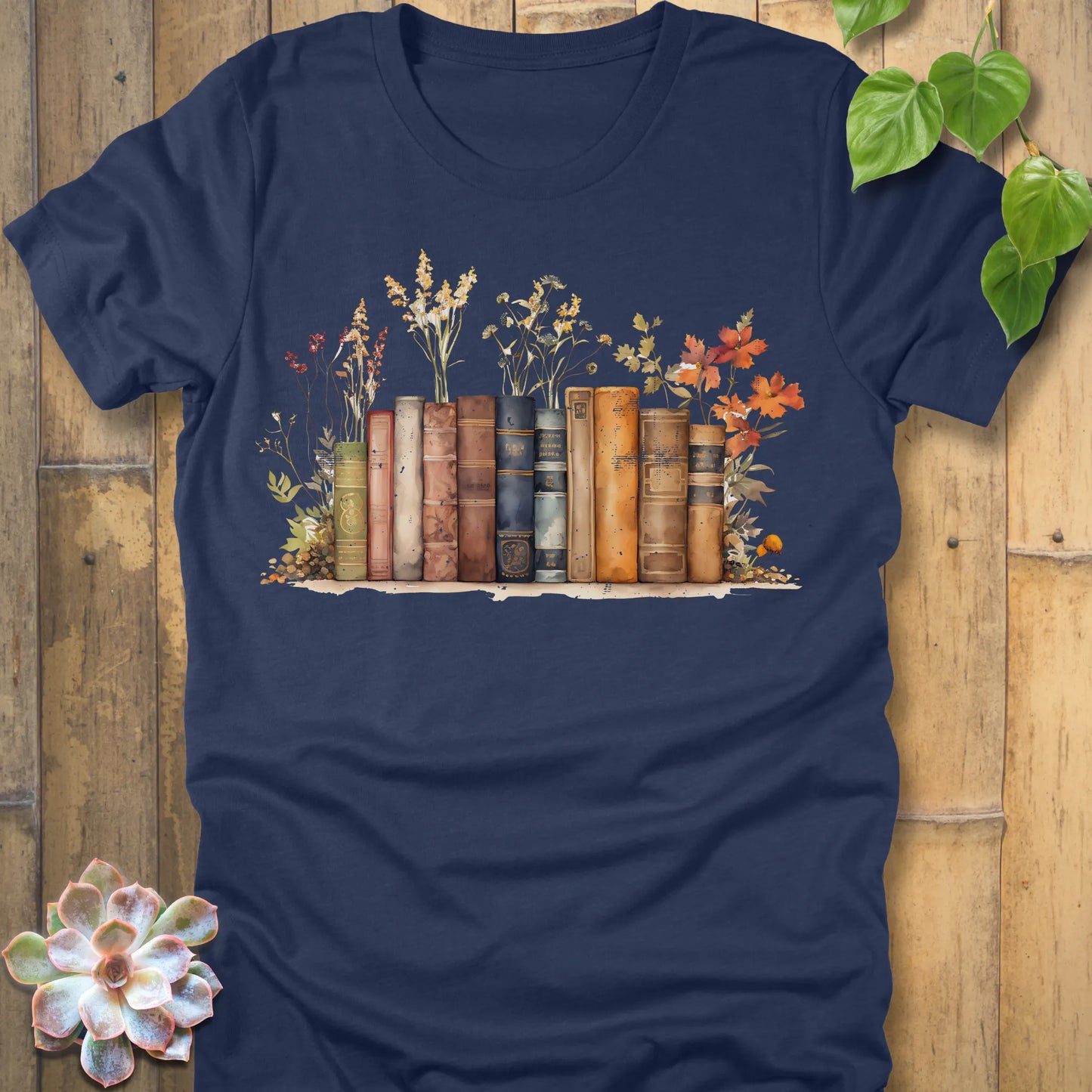 Heather Navy t-shirt featuring the design Wildflower Library printed with books and plants, floral graphic tee for plant lovers.