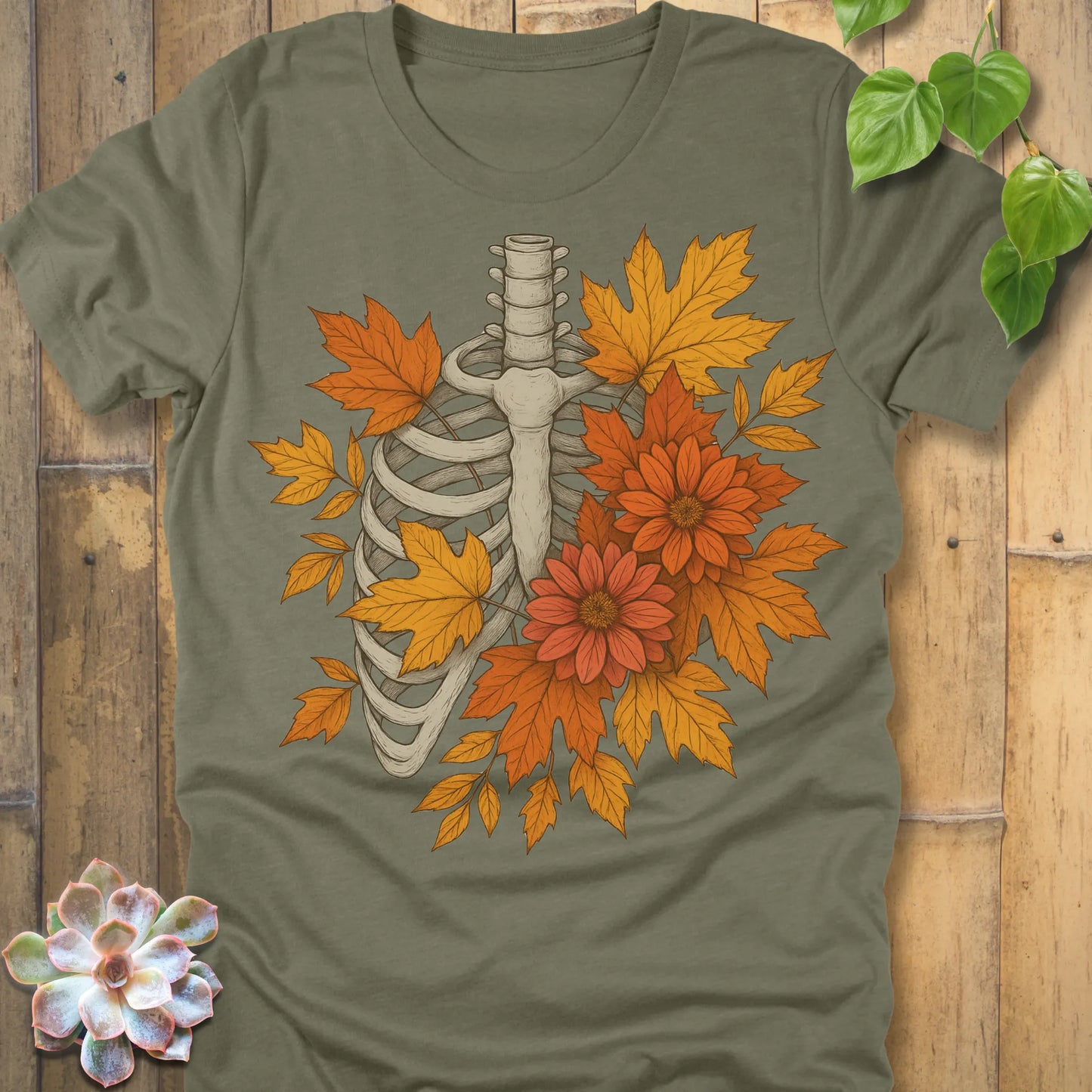 Heather Olive t-shirt featuring the design Autumn Bones printed Halloween skeleton shirt with flowers and leaves.