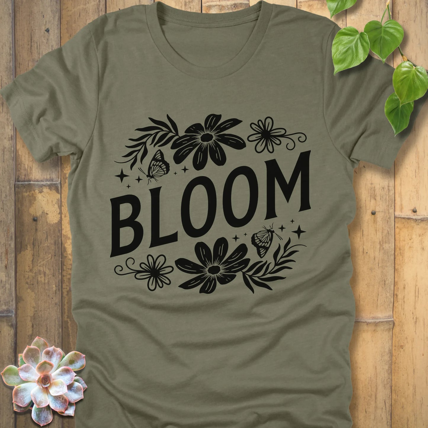 Heather Olive t-shirt featuring the design " Bloom " printed in bold black letters with flowers