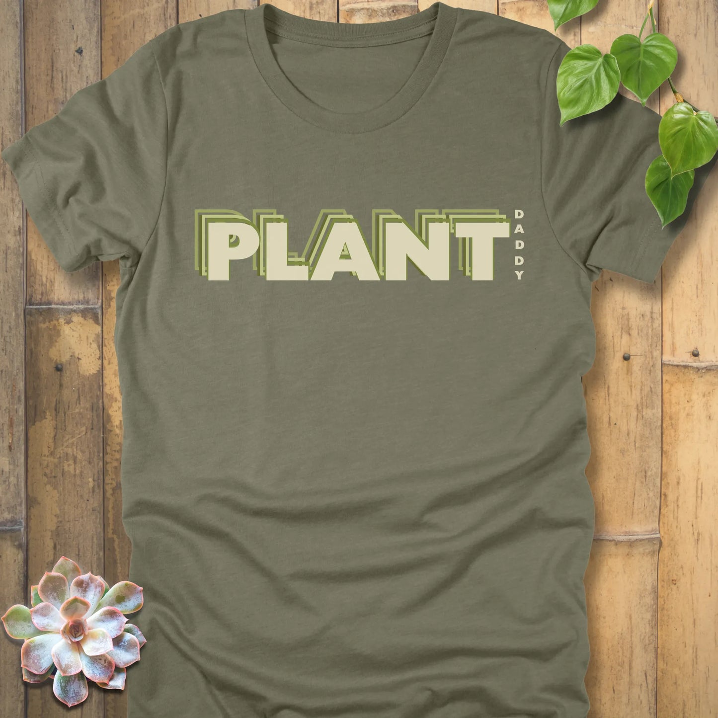 Heather Olive t-shirt featuring the design Plant Daddy printed in bold letters, soft cotton botanical shirt.