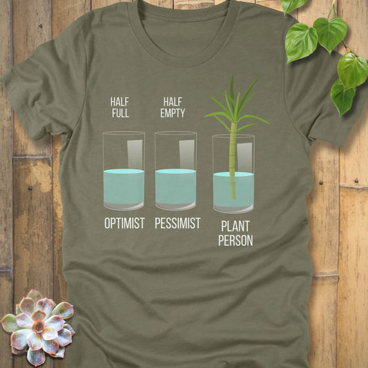 Heather Olive t-shirt featuring the design Plant Person printed in bold letters printed in glass of water, and a plant