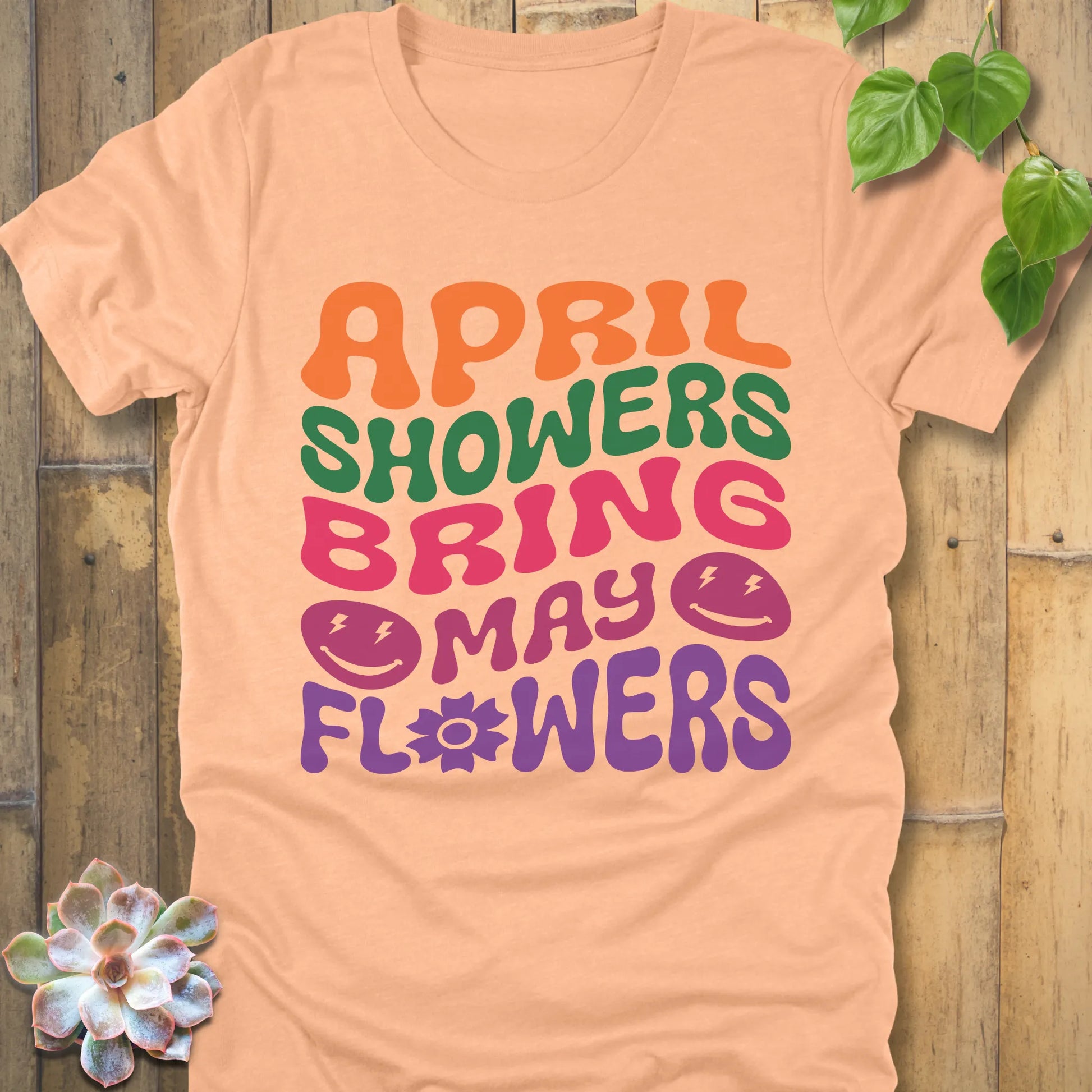 Heather Peach t-shirt featuring the design April Shower printed in bold colorful letters, casual gardening shirt.