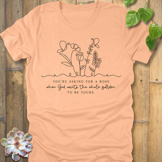 Heather Peach t-shirt featuring the design Asking for a rose, printed in black letters, soft pastel cotton shirt