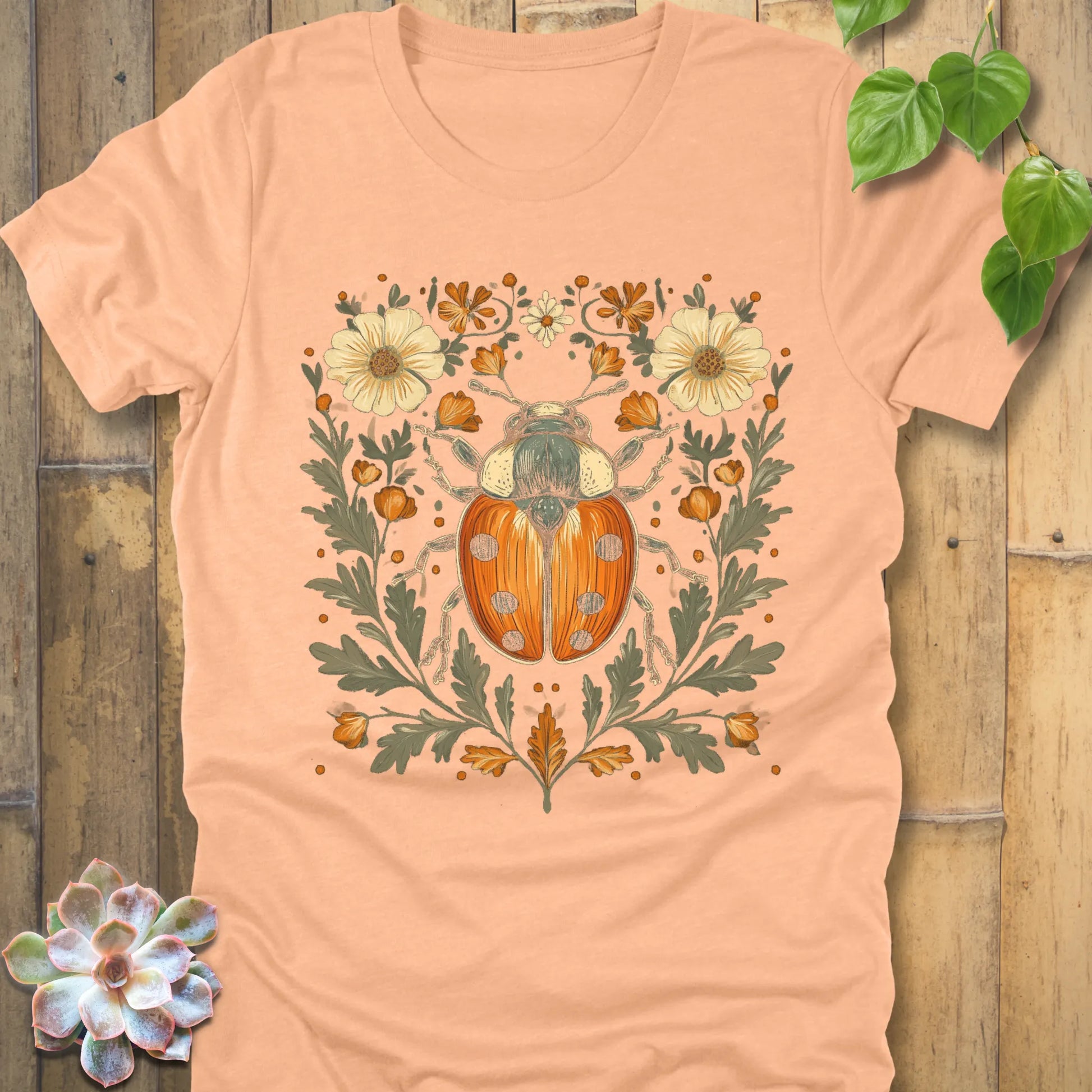 Heather Peach t-shirt featuring the design Blossom Beetle printed with flowers and the beetle