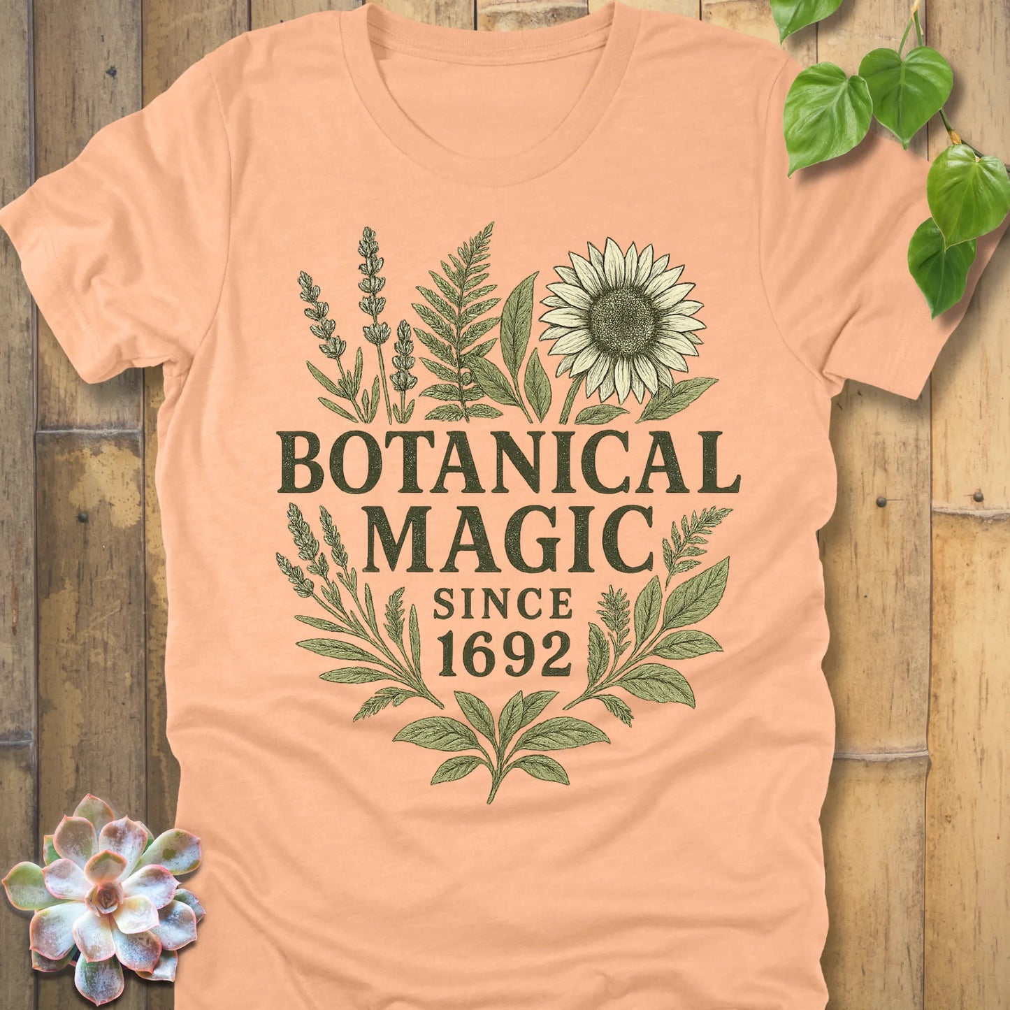 Heather Peach t-shirt featuring the design Botanical Magic printed in bold letters, botanical garden shirt.