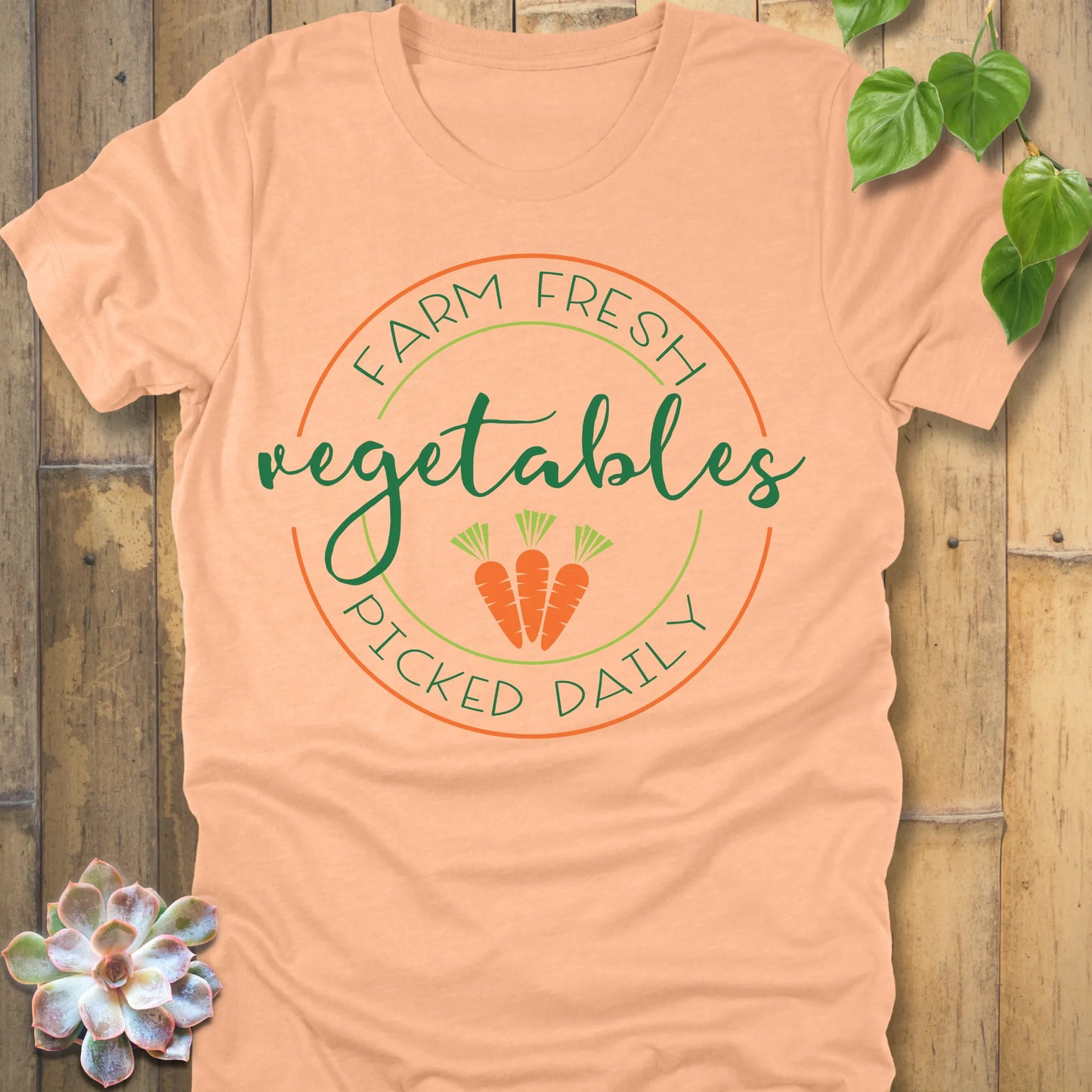 Heather Peach t-shirt featuring the design Fresh Vegetables printed in green letters and some carrots, organic vegetable lover shirt.