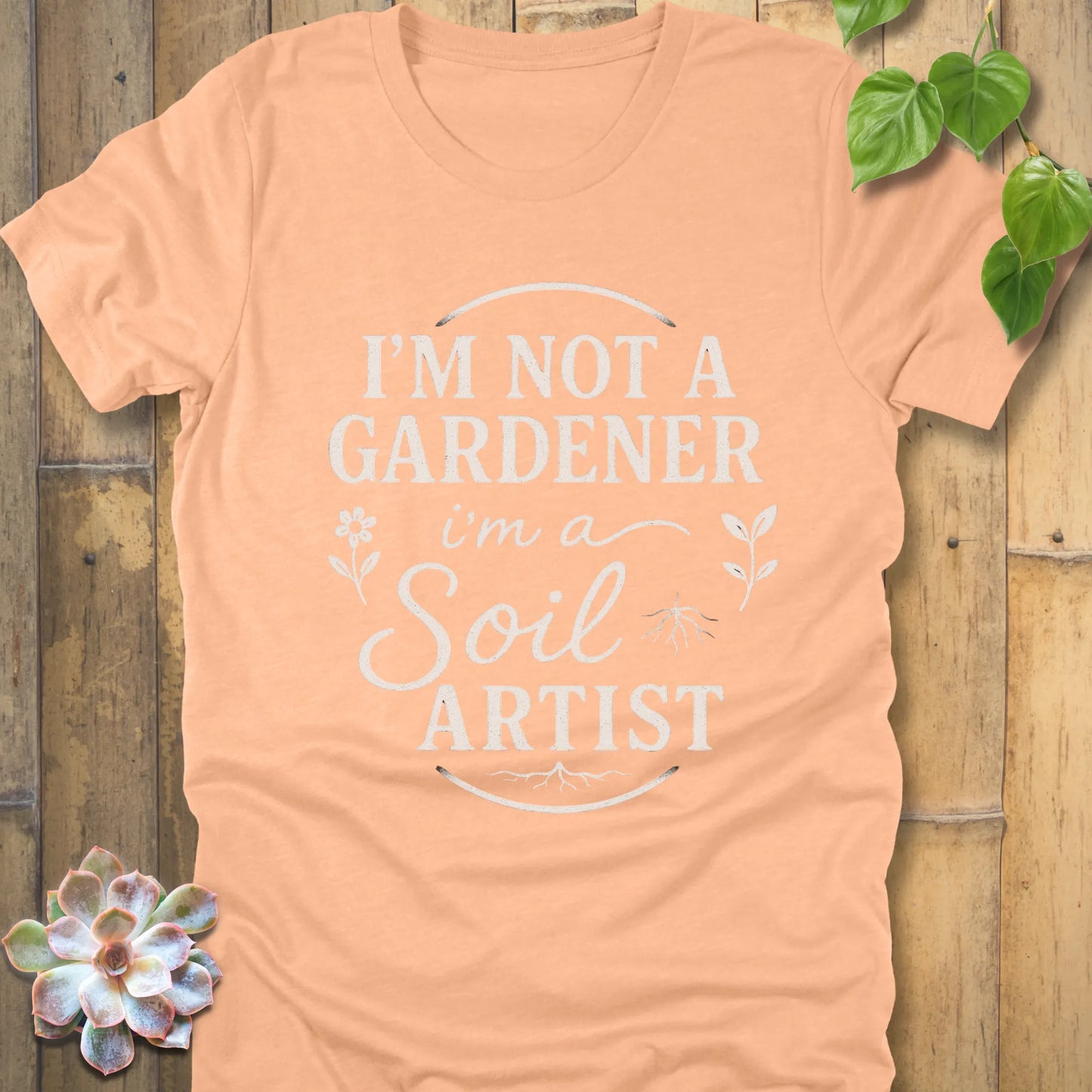 Heather Peach t-shirt featuring the design I'm Not a Gardener I'm a Soil Artist printed in bold white letters