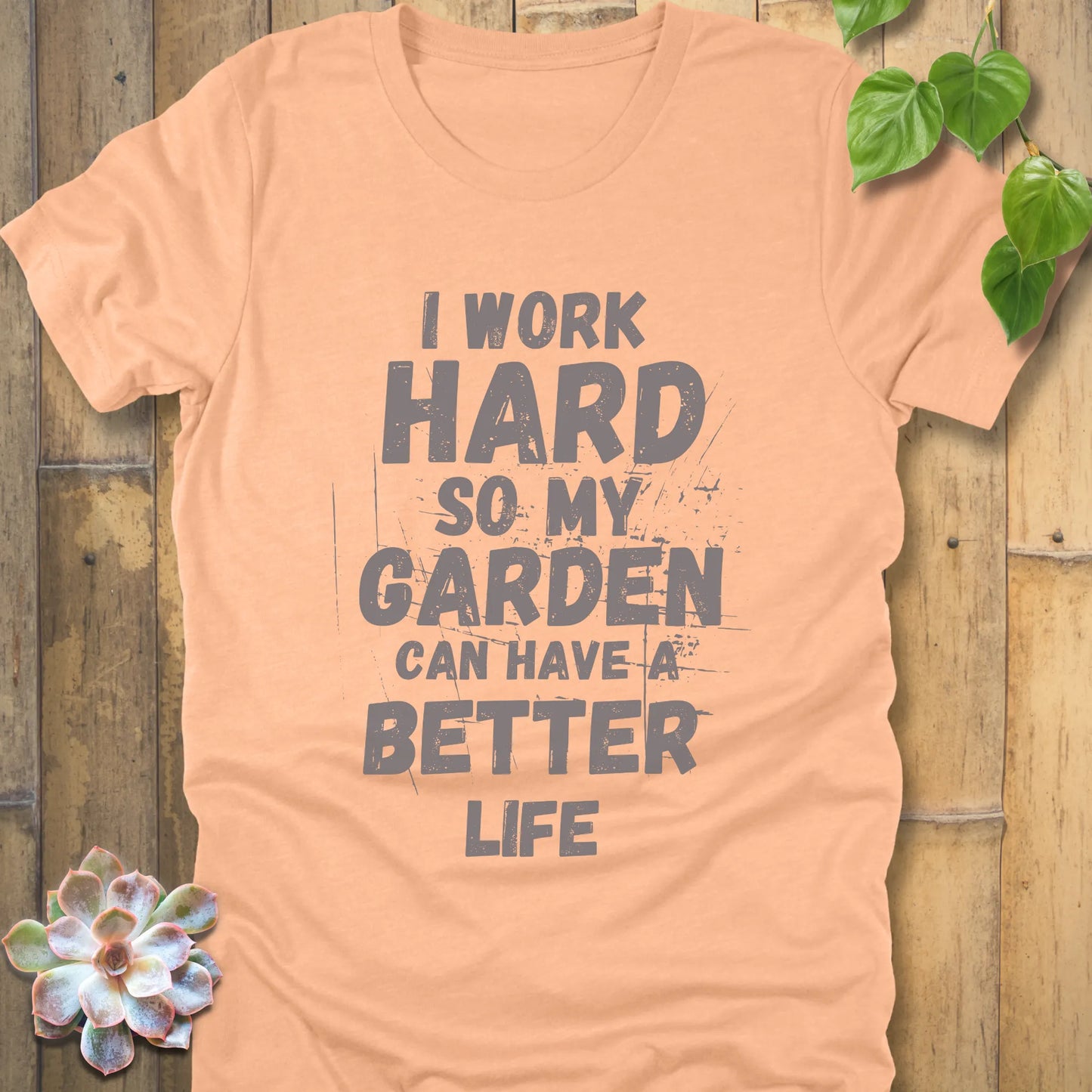 Heather Peach t-shirt featuring the design I work hard so my garden can have a better life in bold lettering.