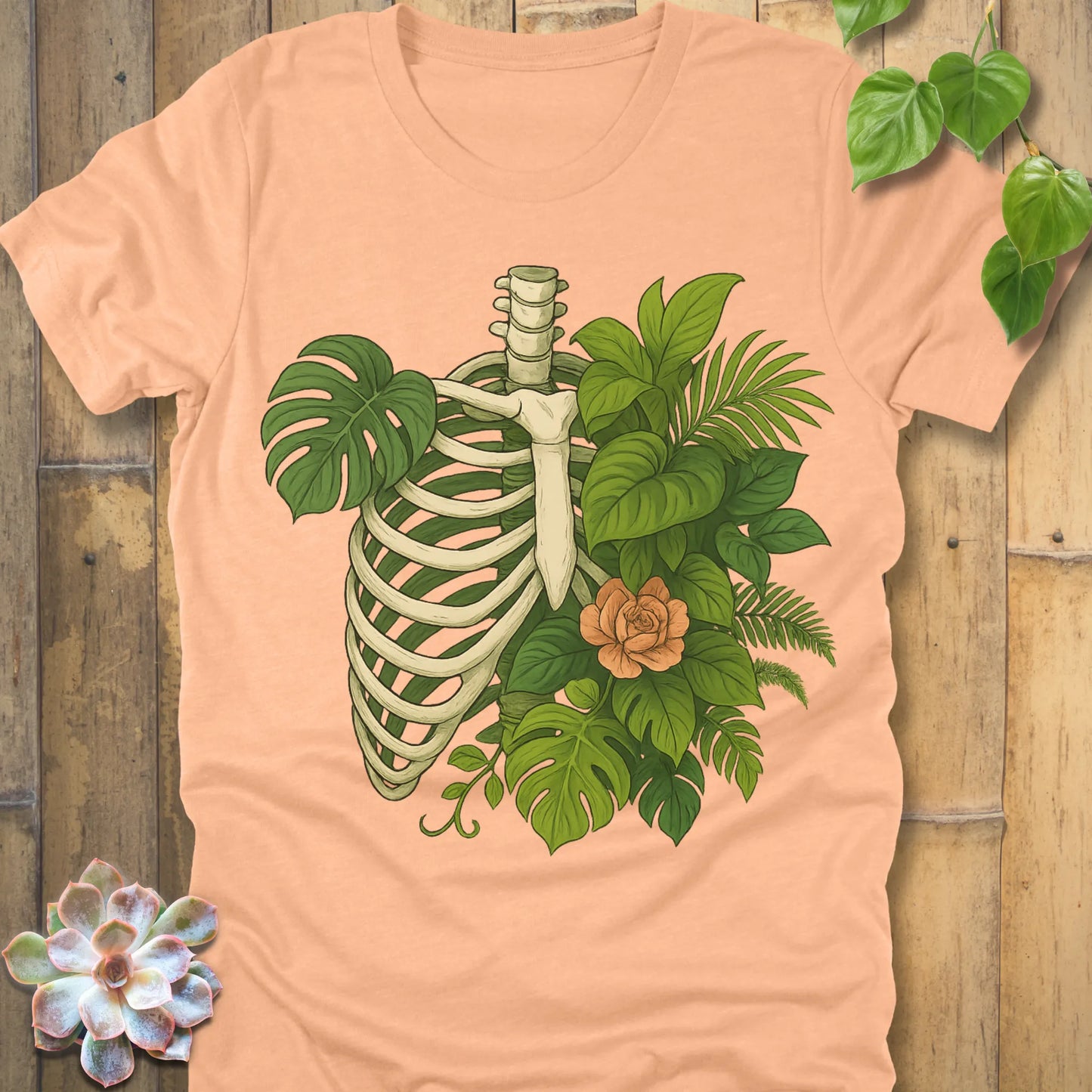 Heather Peach t-shirt featuring the design Jungle Bones printed in bones, leaves and flowers, casual jungle graphic shirt.