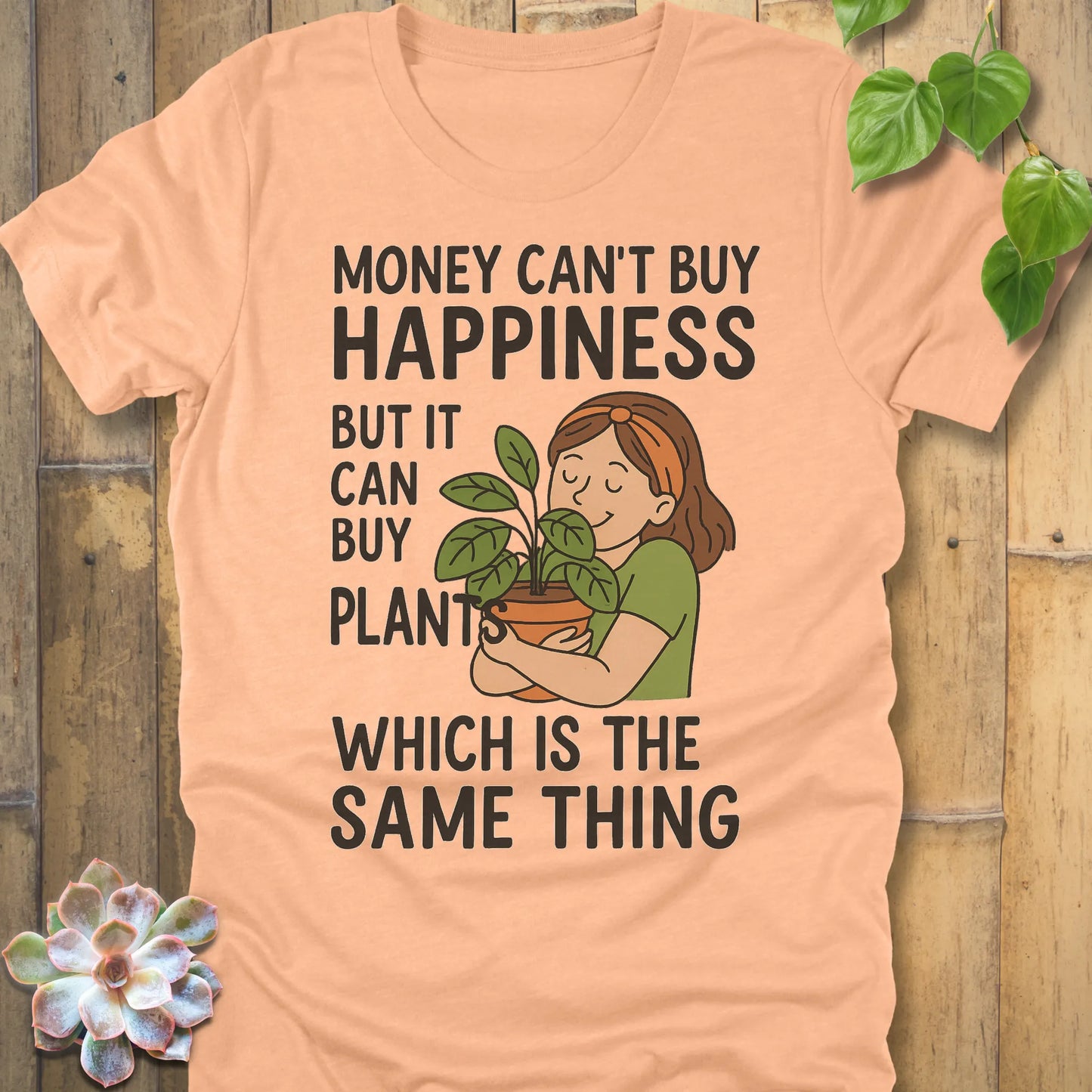 Heather Peach t-shirt featuring the design Money Can Buy Happiness printed in bold black letters, casual streetwear shirt.