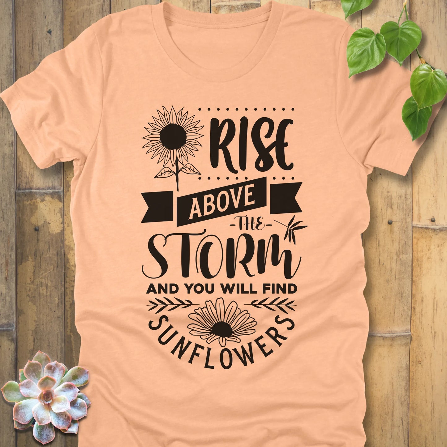 Heather Peach t-shirt featuring the design Rise above the storm and you will find sunflowers printed in white letters