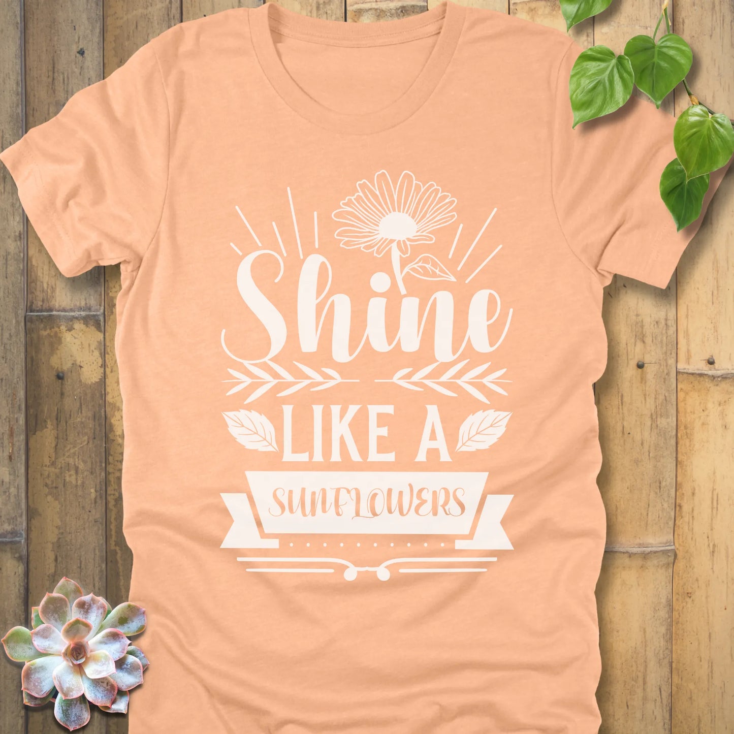 Heather Peach t-shirt featuring the design Shine Like A Sunflower printed in bold letters with sunflower