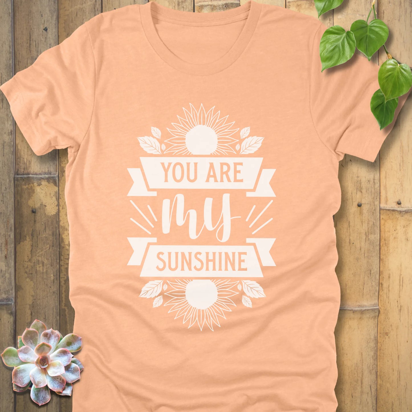 Heather Peach t-shirt featuring the design You are my sunshine printed in bold letters with a sunflower graphic