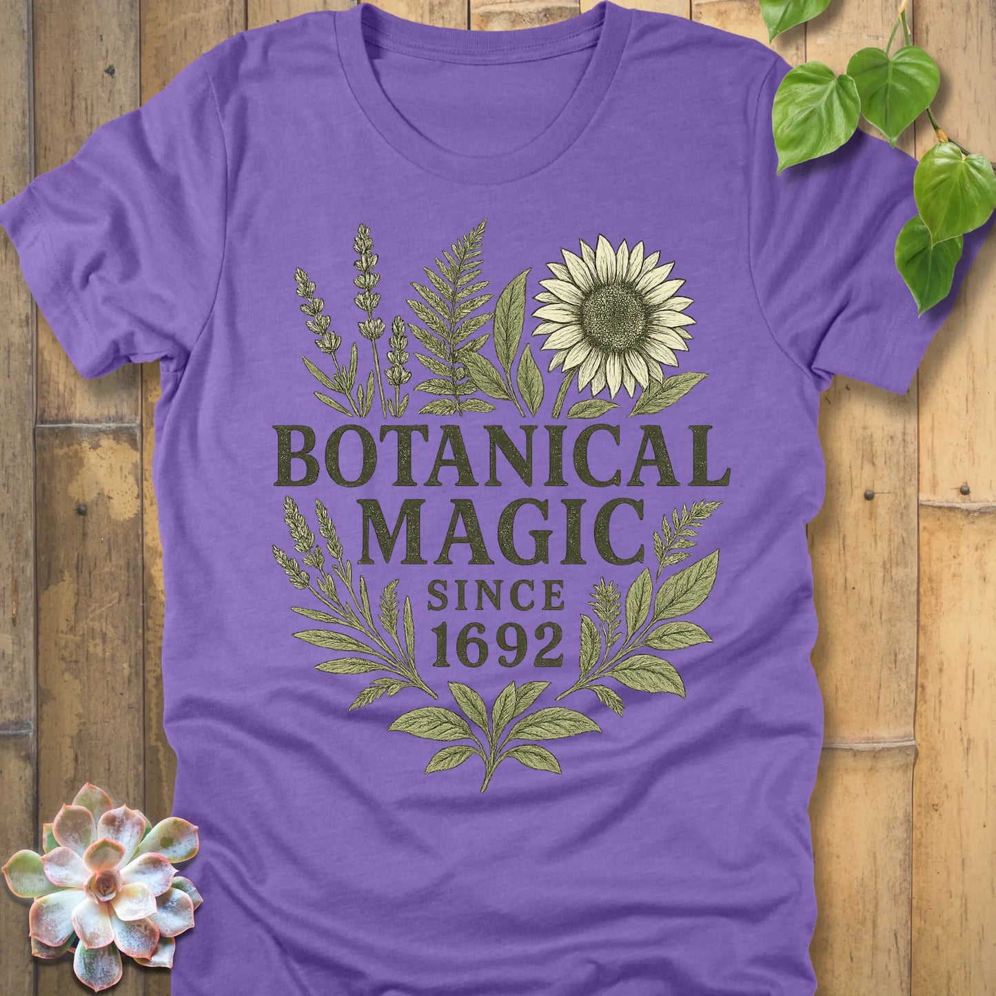 Heather Team Purple t-shirt featuring the design Botanical Magic printed in bold letters, botanical garden shirt.
