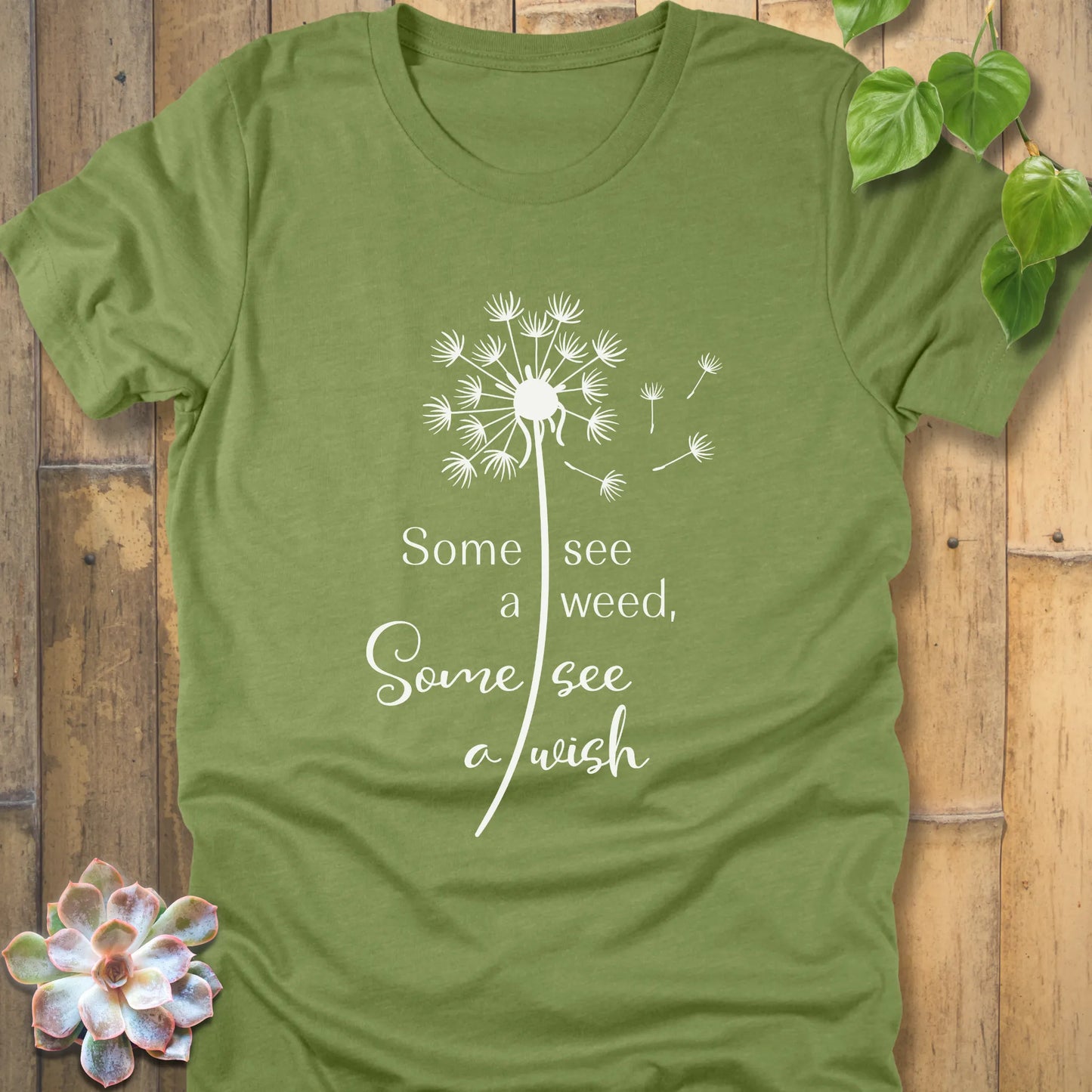 Heather green t-shirt featuring the dandelion design with the quote "Some see a weed, Some see a wish"